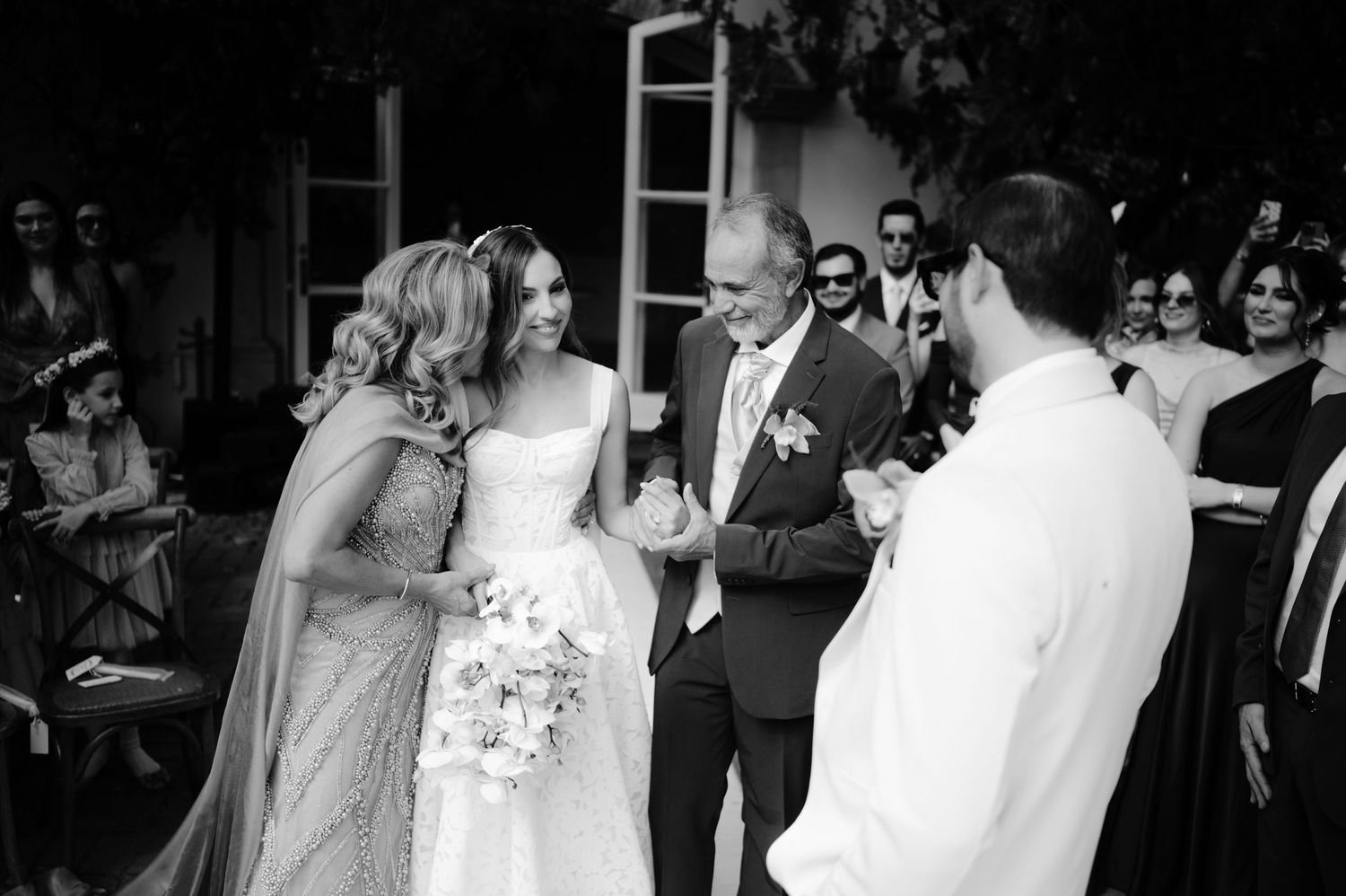 A couple shares their first dance at a wedding reception while guests watch from the surrounding tables.