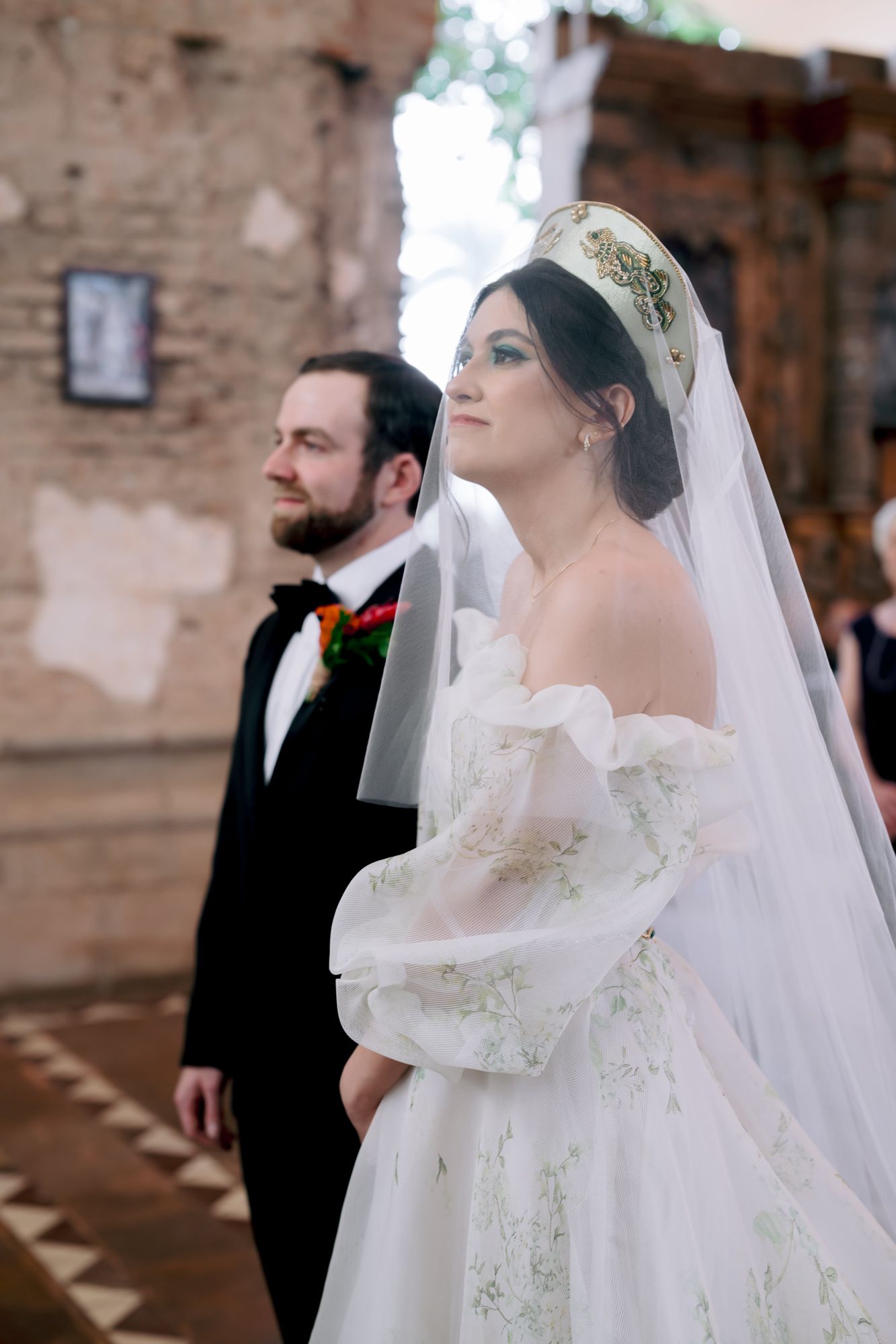 Wedding ceremony scene in a historic church with traditional decorative elements.
