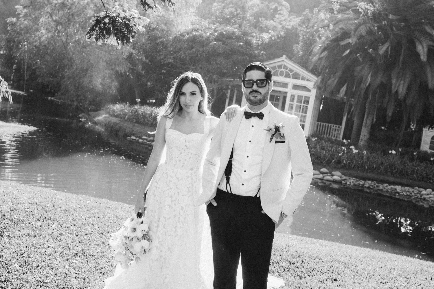 Black and white wedding photos captured in a scenic outdoor garden setting.