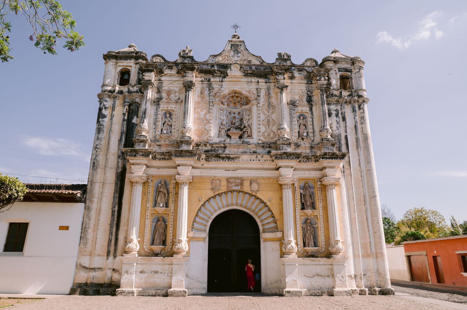 Ornate colonial church facade with baroque architectural details and arched entrance in Central America.