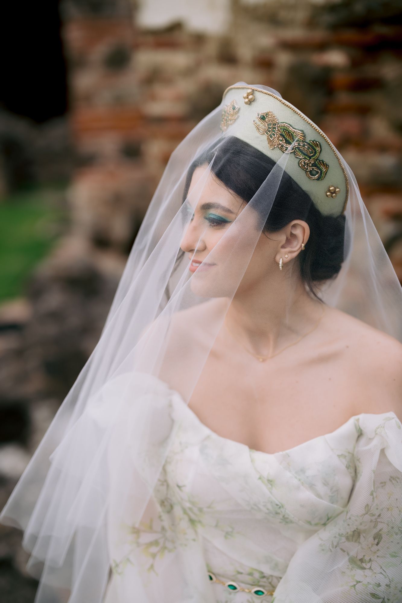 Close-up bridal portrait highlighting ornate crown and delicate veil details.