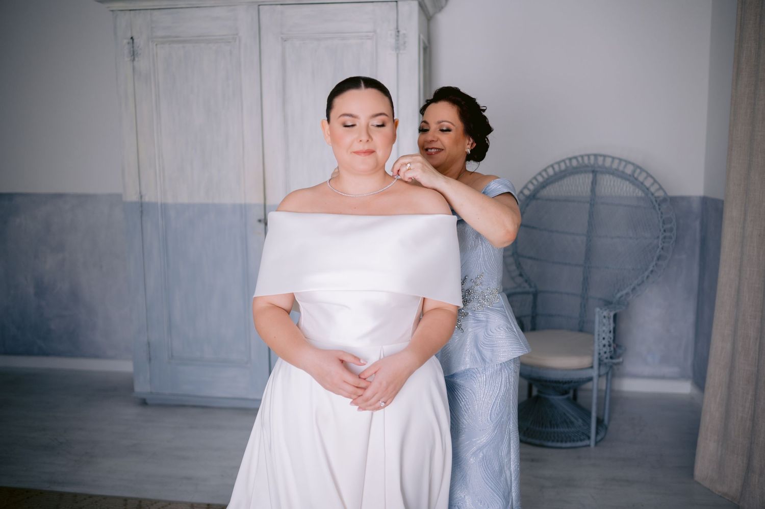 Wedding preparation scene in a room with blue walls and vintage furniture.
