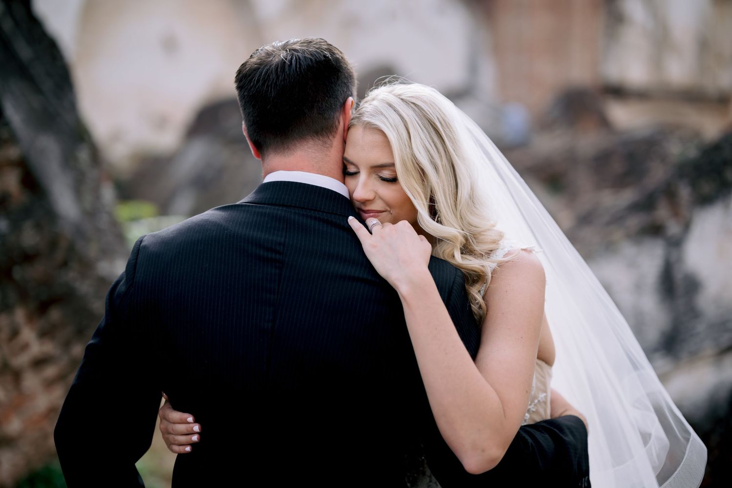 A tender moment between newlyweds as they embrace during their wedding photoshoot at historic ruins.