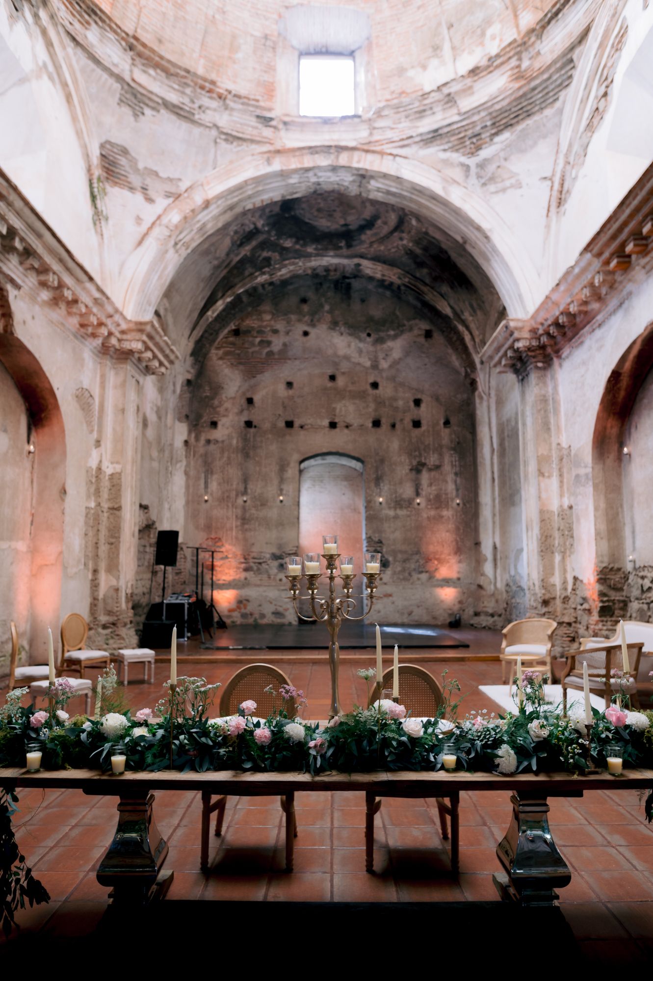 Interior of historic church with vaulted ceilings and elegant wedding reception setup.