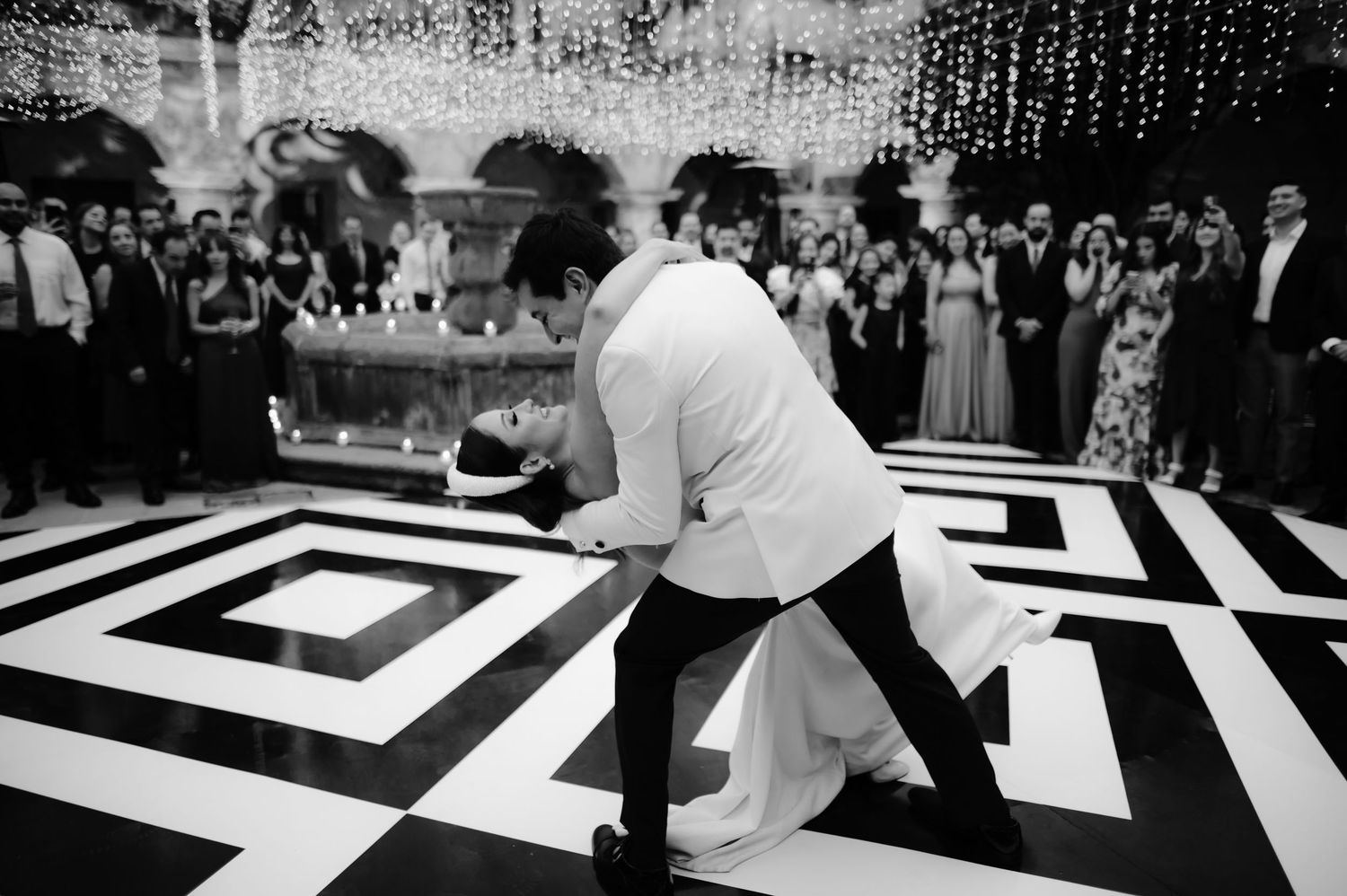 Black and white dance floor with geometric pattern at wedding reception.
