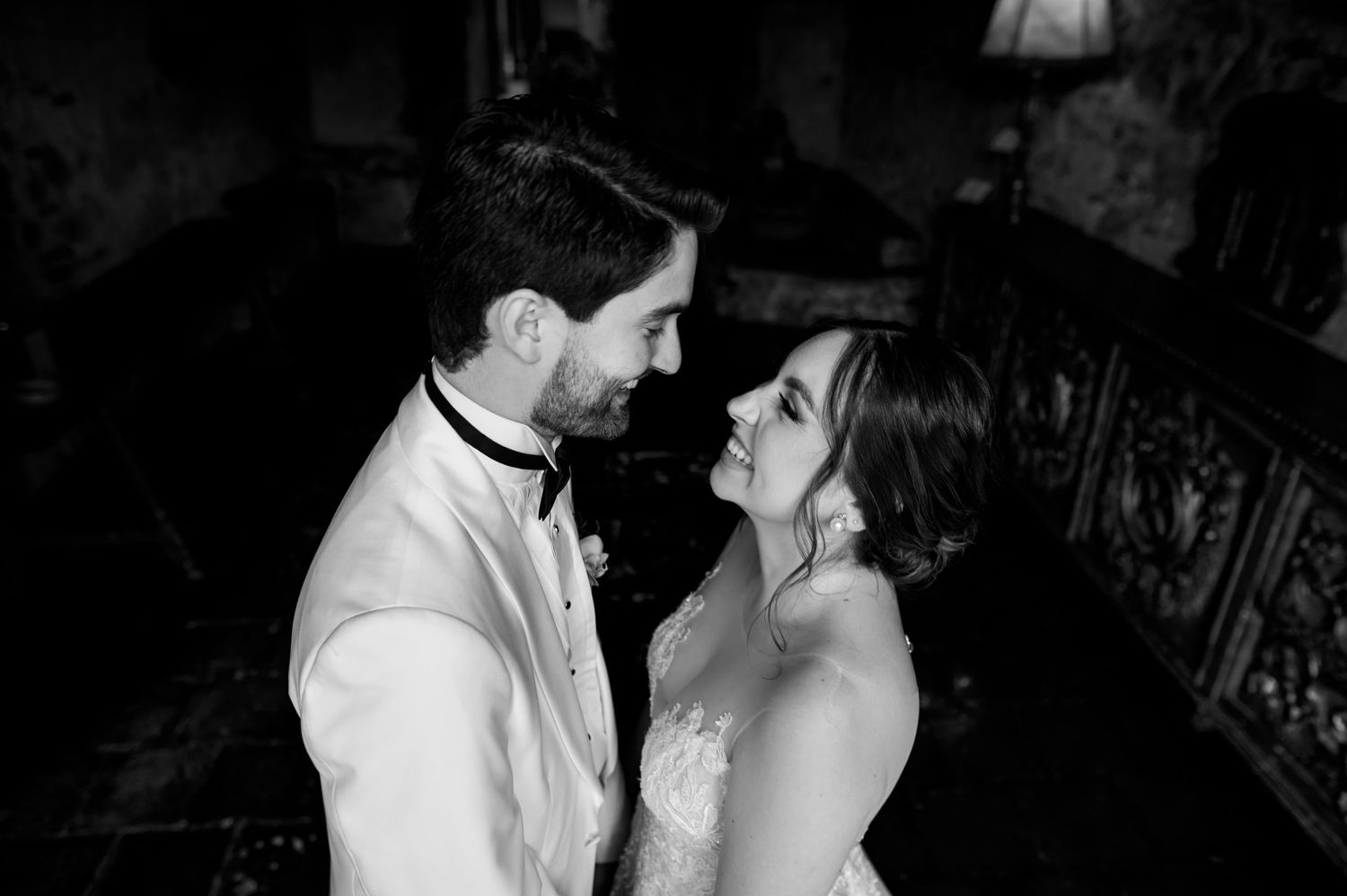 Black and white portrait captures intimate moment between newlyweds.