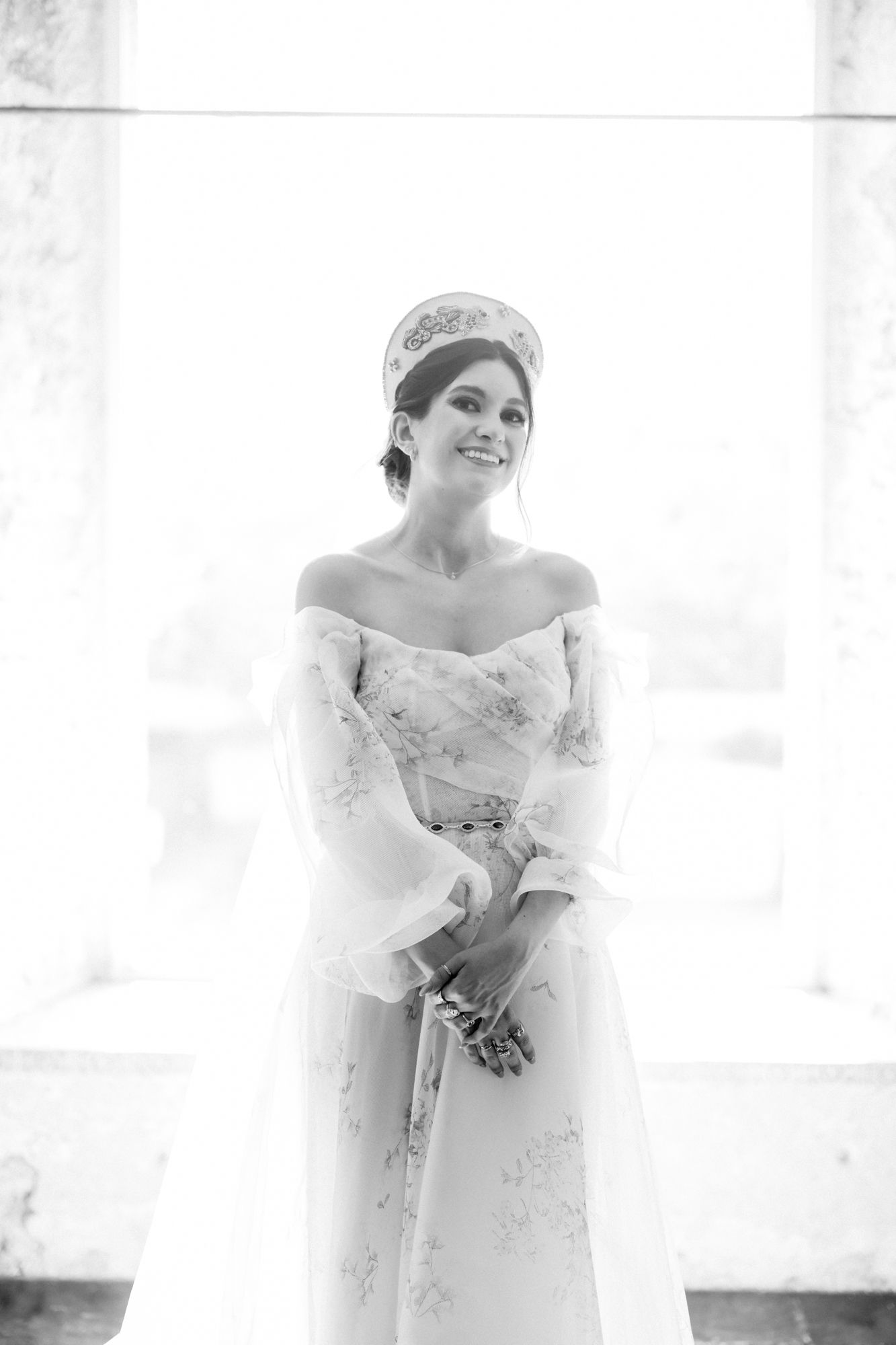 High-key black and white bridal portrait in off-shoulder gown and crown.