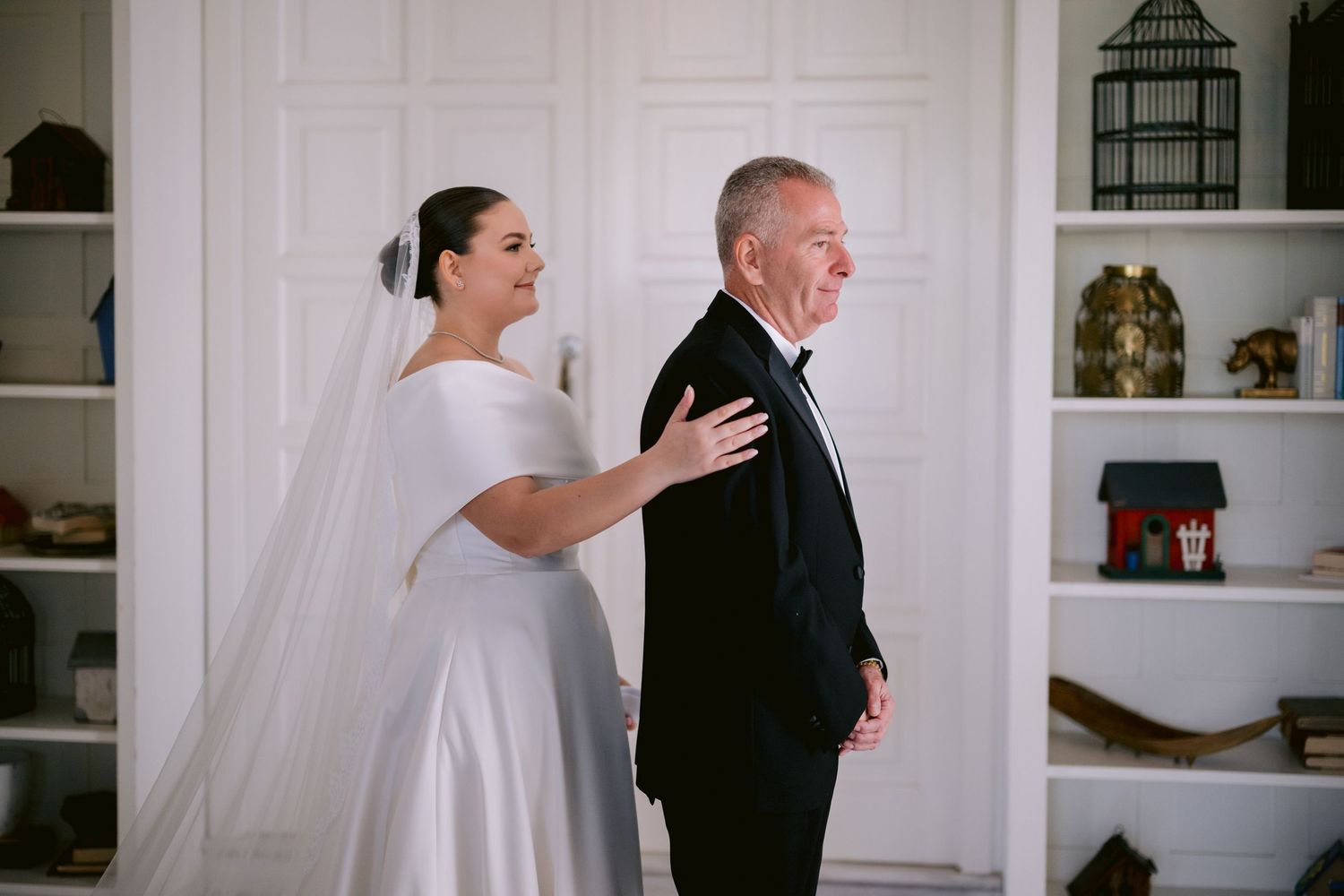 First look moment between bride and father before wedding ceremony.