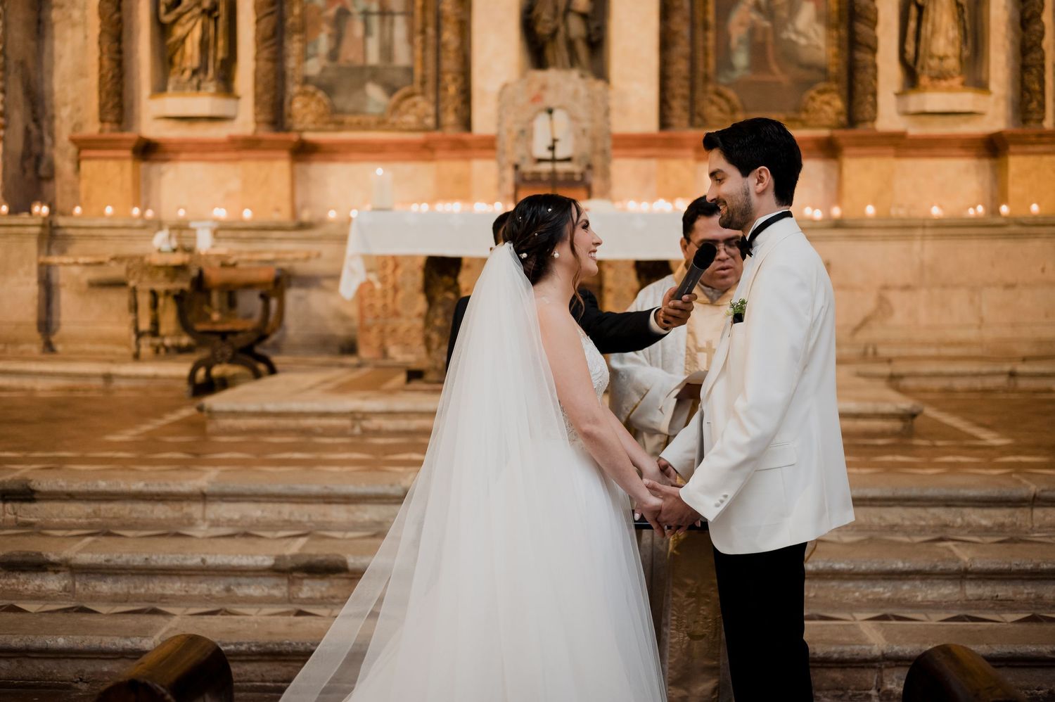 A wedding ceremony moment in an ornate church with religious artwork in the background.