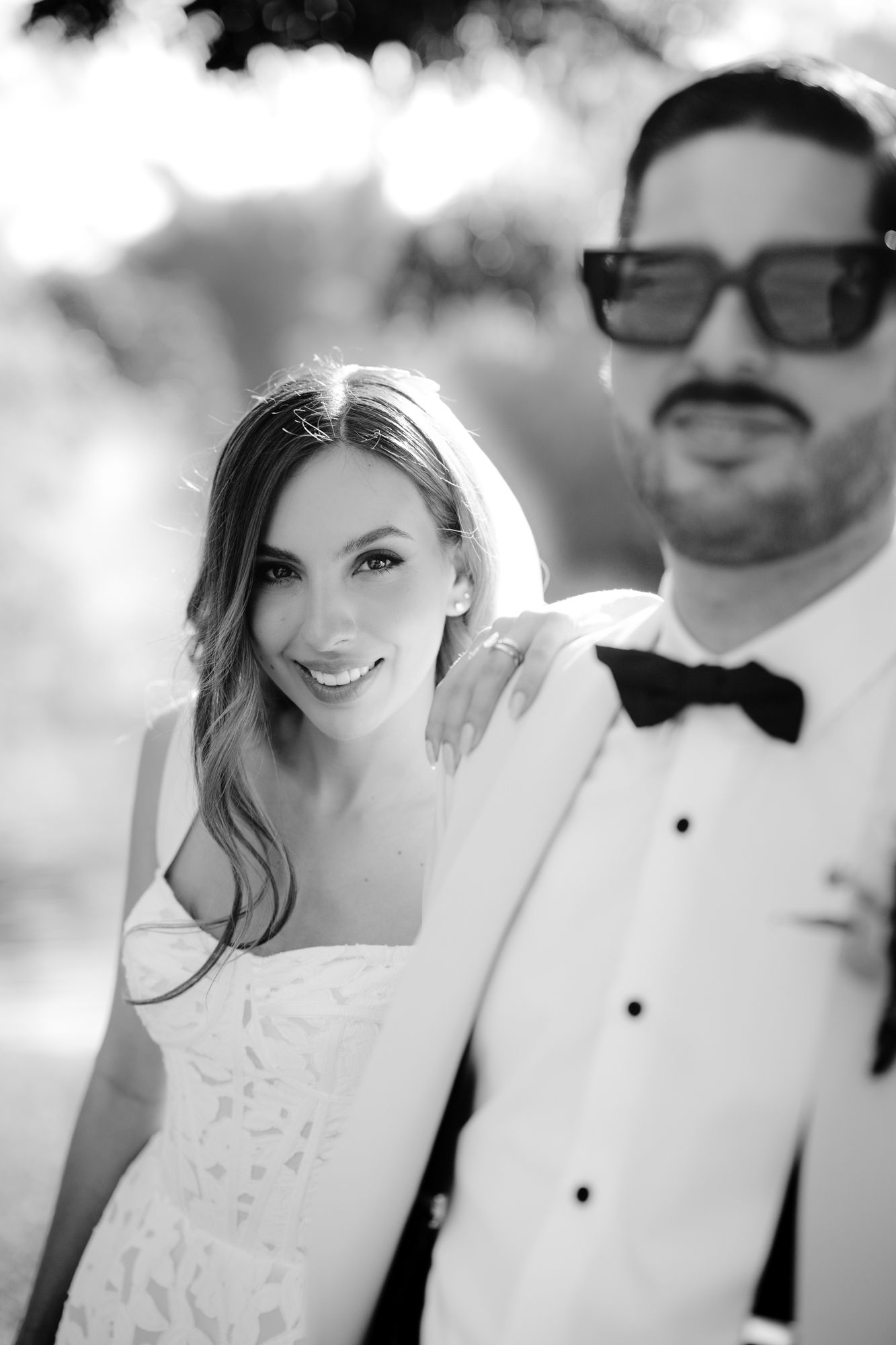 Intimate black and white wedding portrait showing couple in formal attire with soft natural lighting.