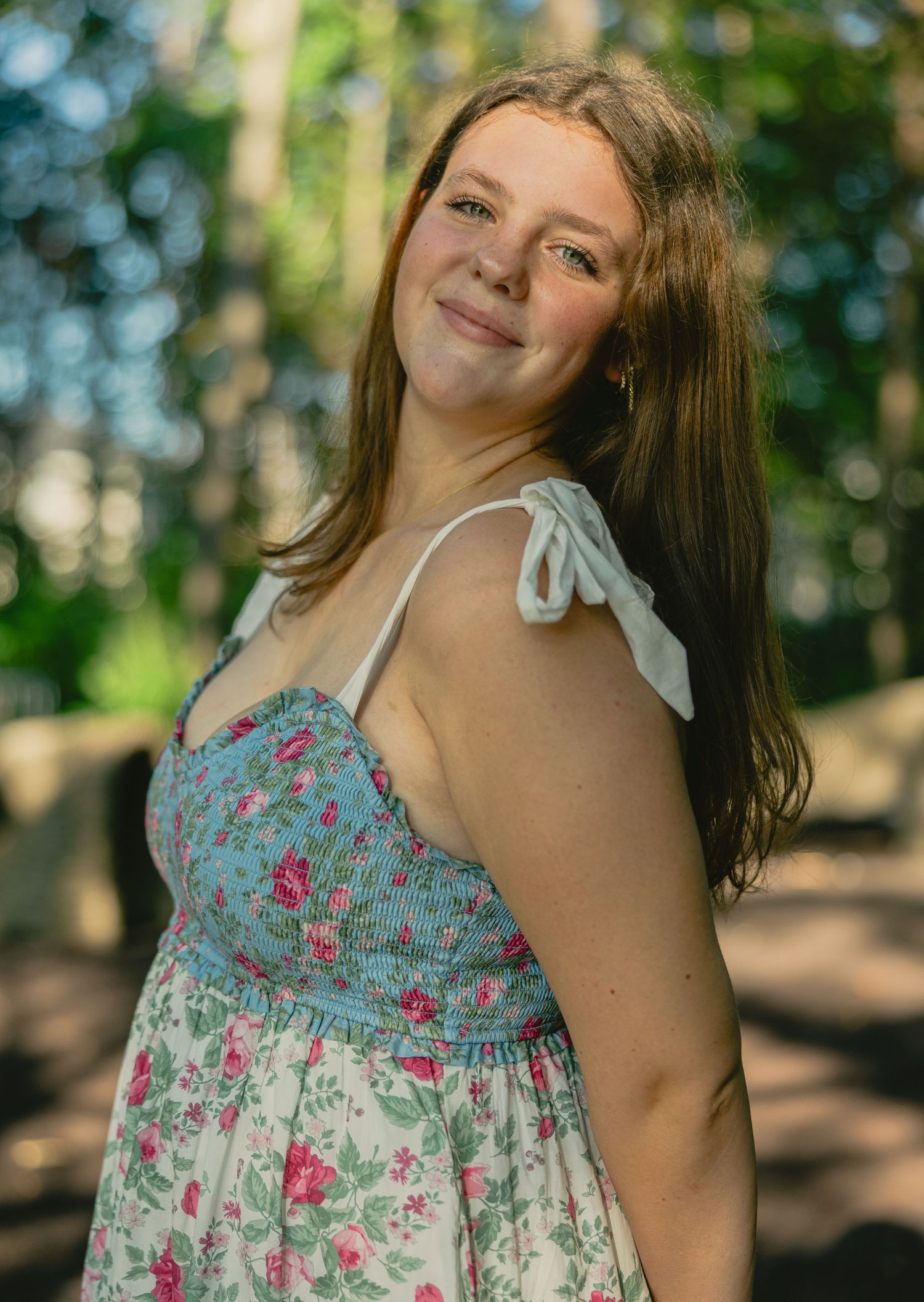 A sequence of outdoor portrait shots featuring someone in a floral sundress against a sunlit forest background.