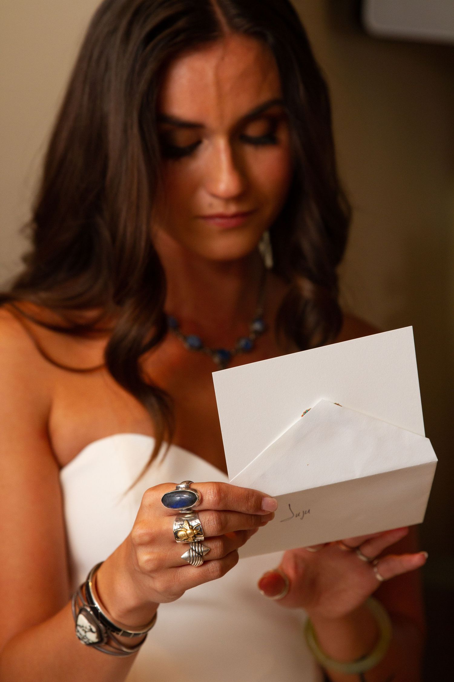 Bride reading a note from her husband before her wedding ceremony