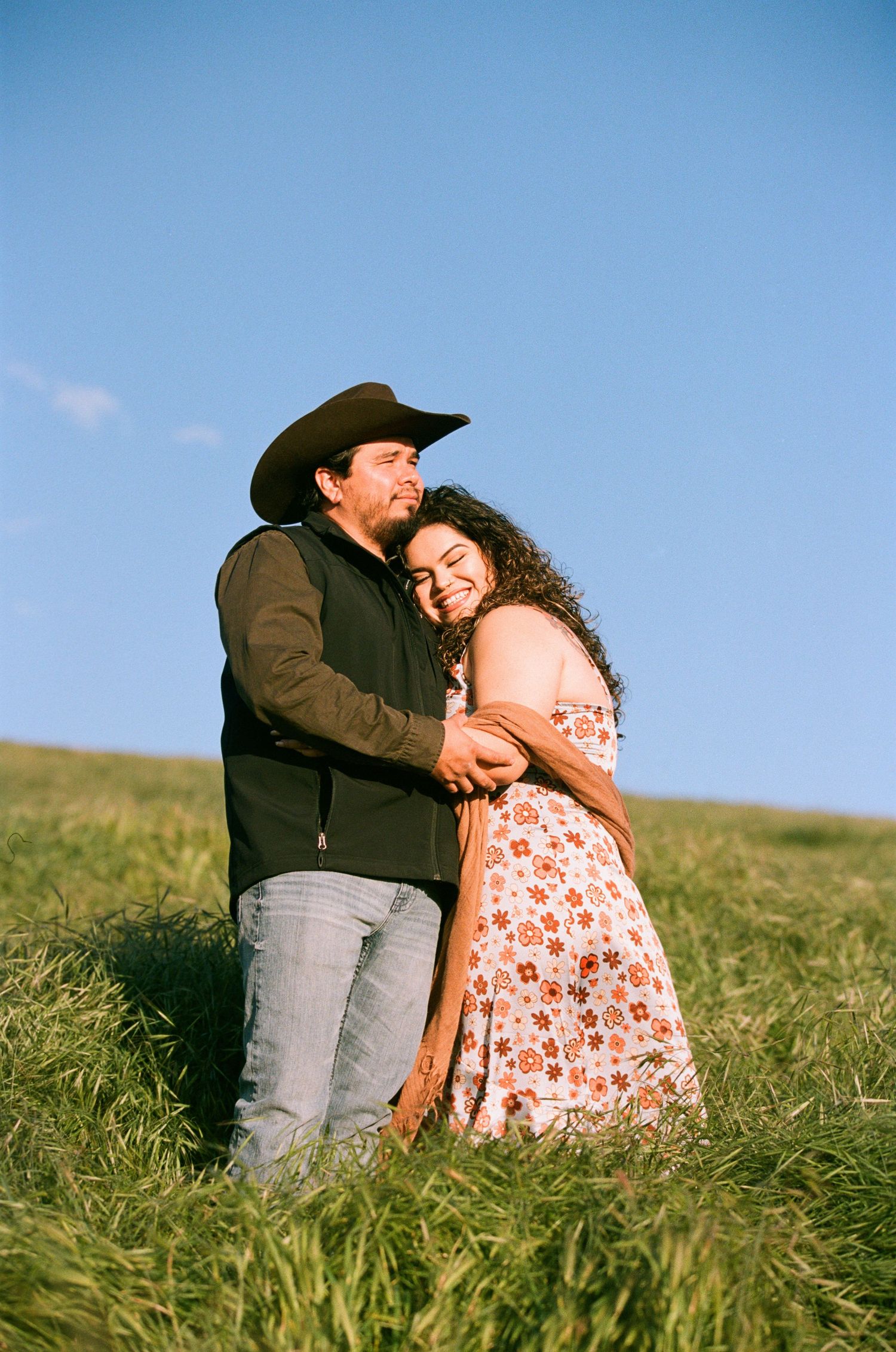 Husband and wife, both photographers embracing