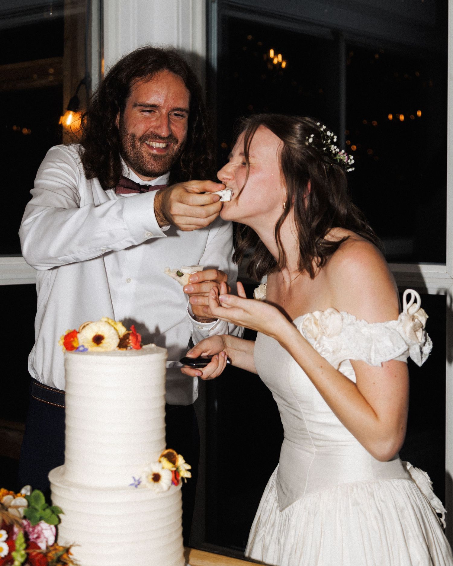 Candid cake cut moment at Quidi Vidi Brewery captured by Newfoundland documentary wedding photographer Kaitlyn Yvette