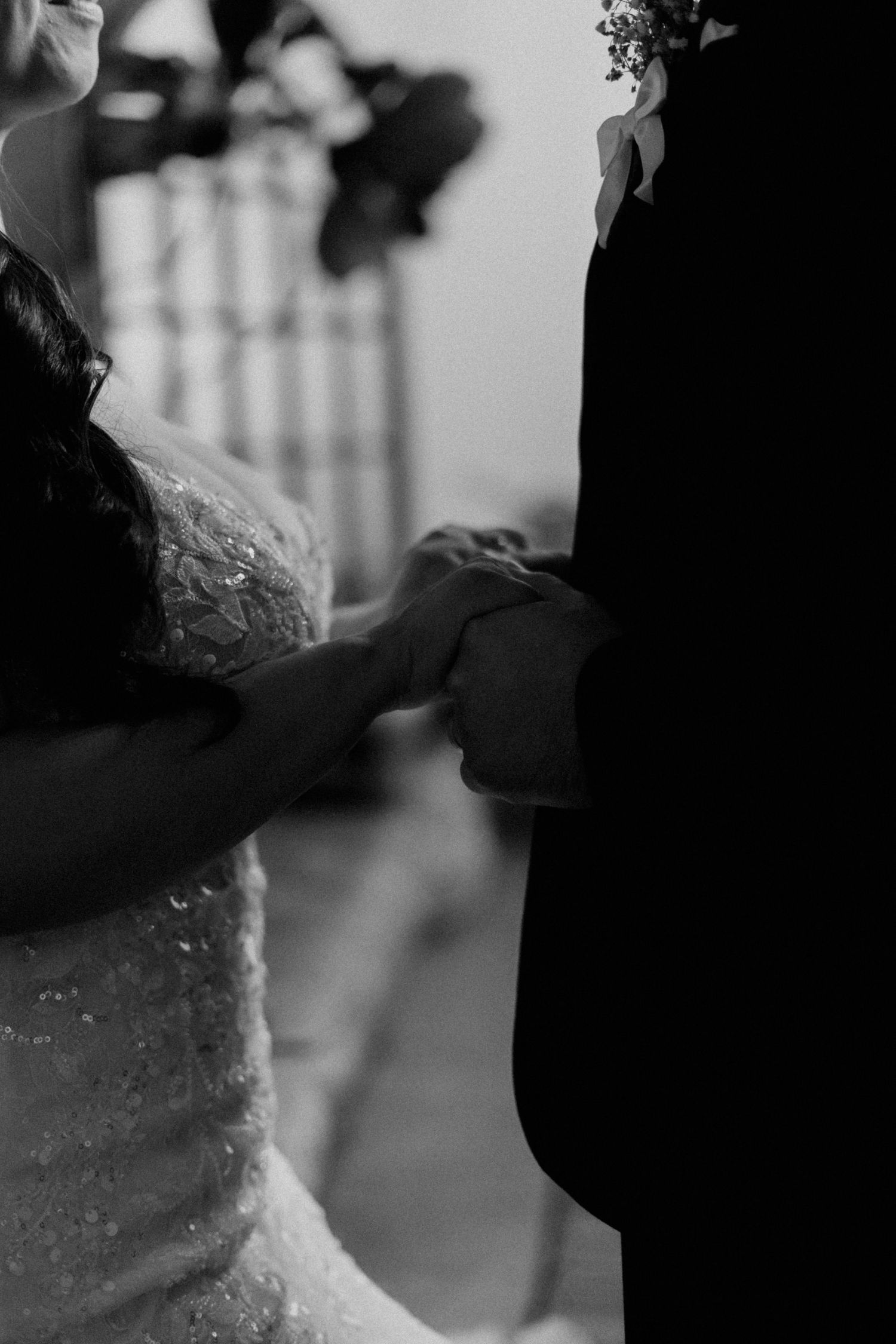 Atmospheric black and white wedding portrait with soft focus and elegant composition.