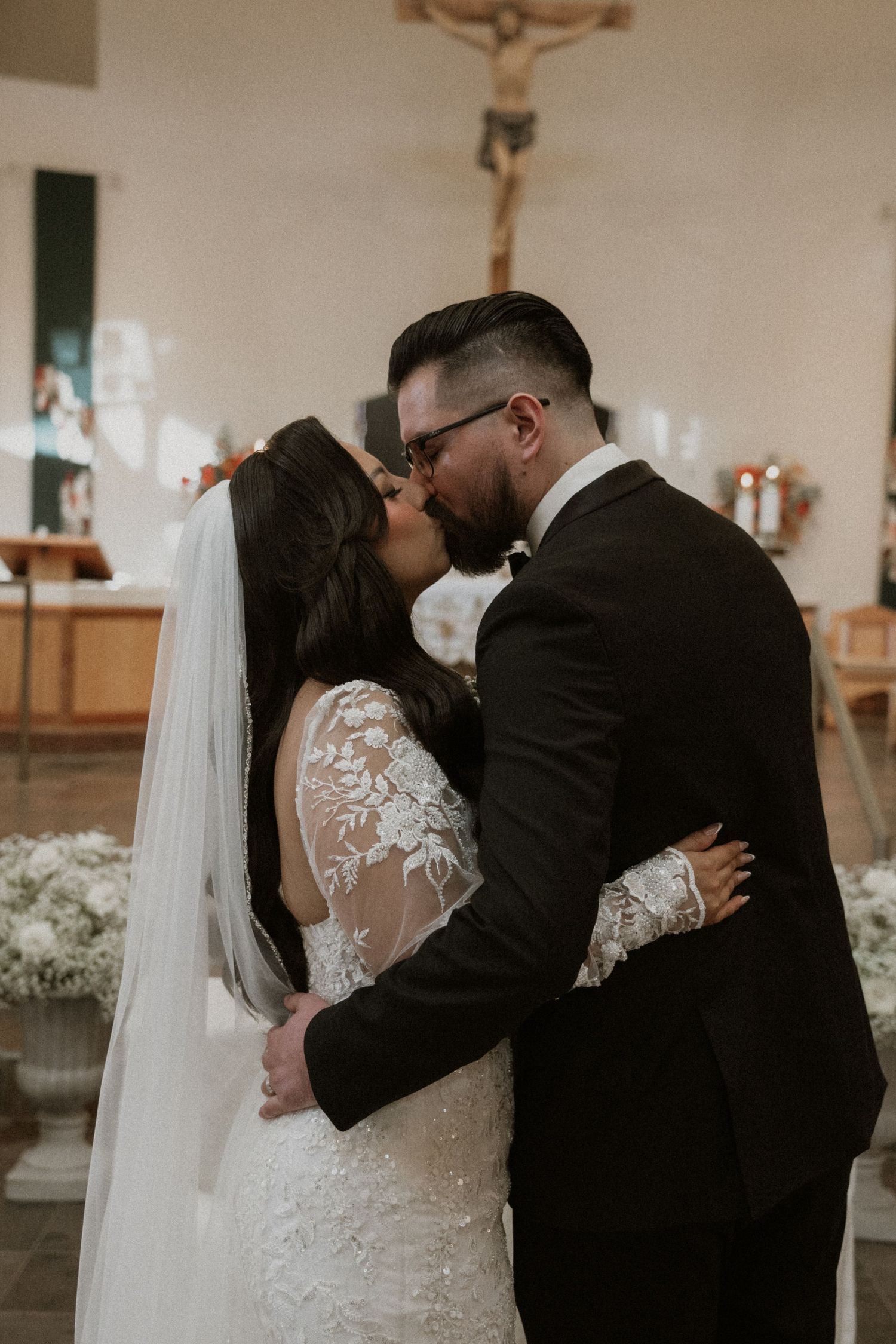A series of romantic wedding kiss photos showing a couple embracing in a church setting.