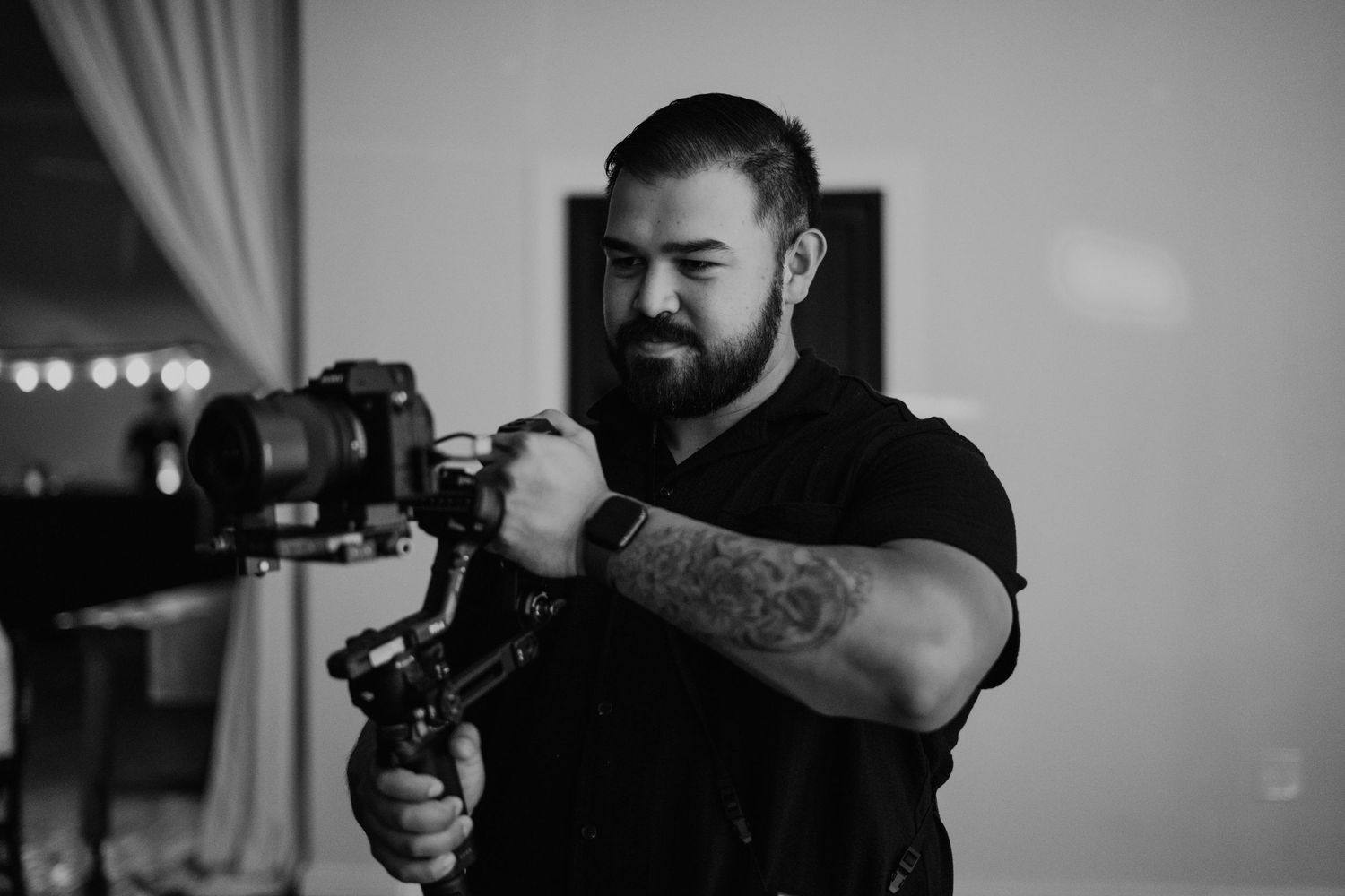 Professional photographer shooting with camera equipment in monochrome.