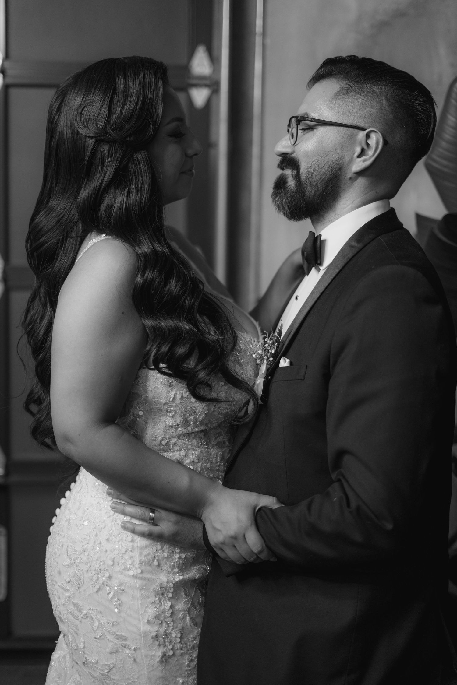 An intimate dance between newlyweds, with the bride wearing a detailed white lace dress.