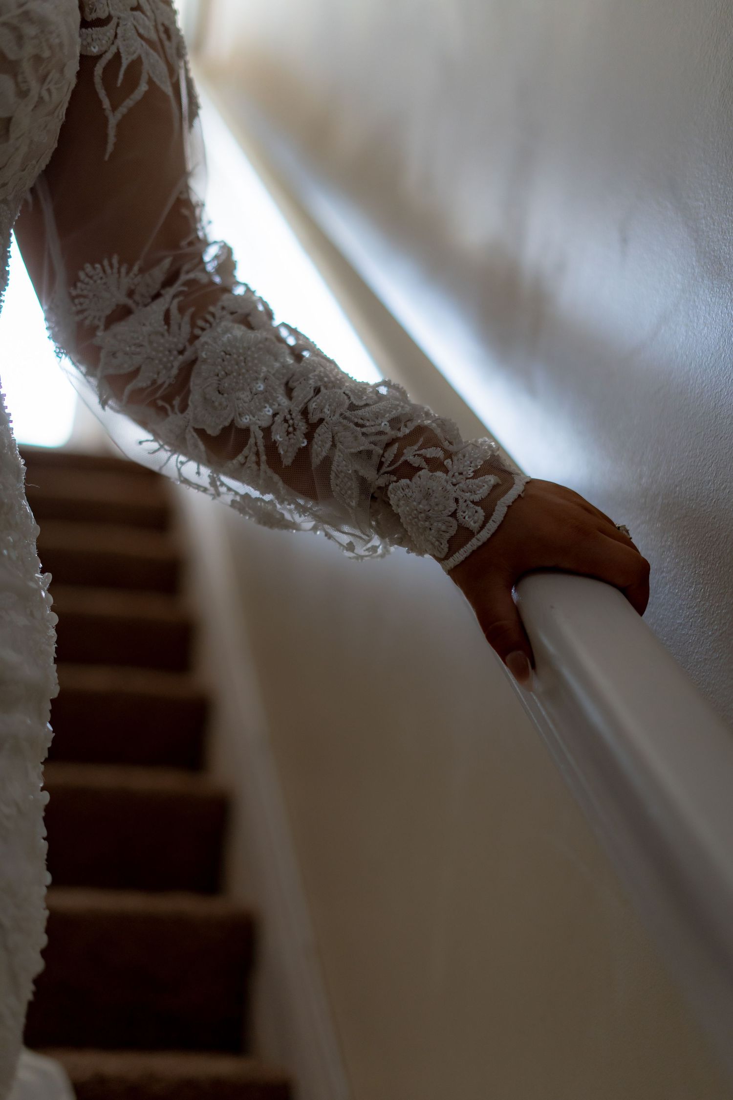 Intricate lace sleeve detail of white wedding gown.
