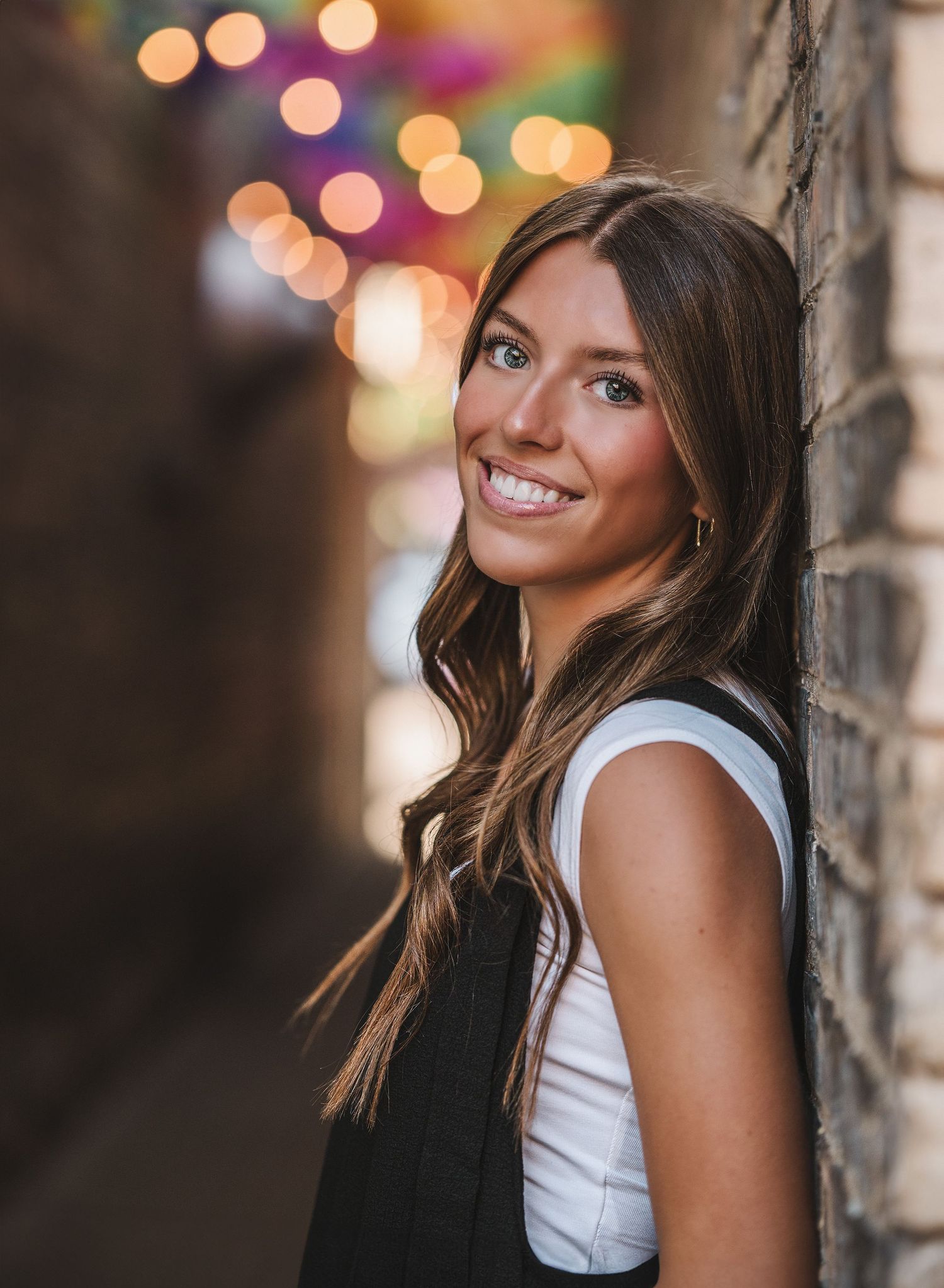 Senior portrait with bokeh lights creating a dreamy background effect.