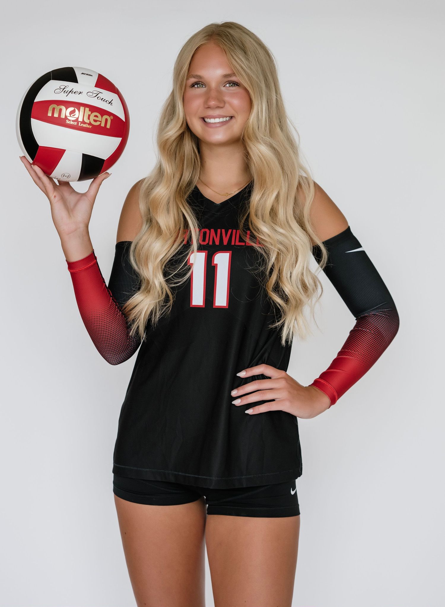 Volleyball player in black and red uniform holds a white volleyball in a series of dynamic poses.