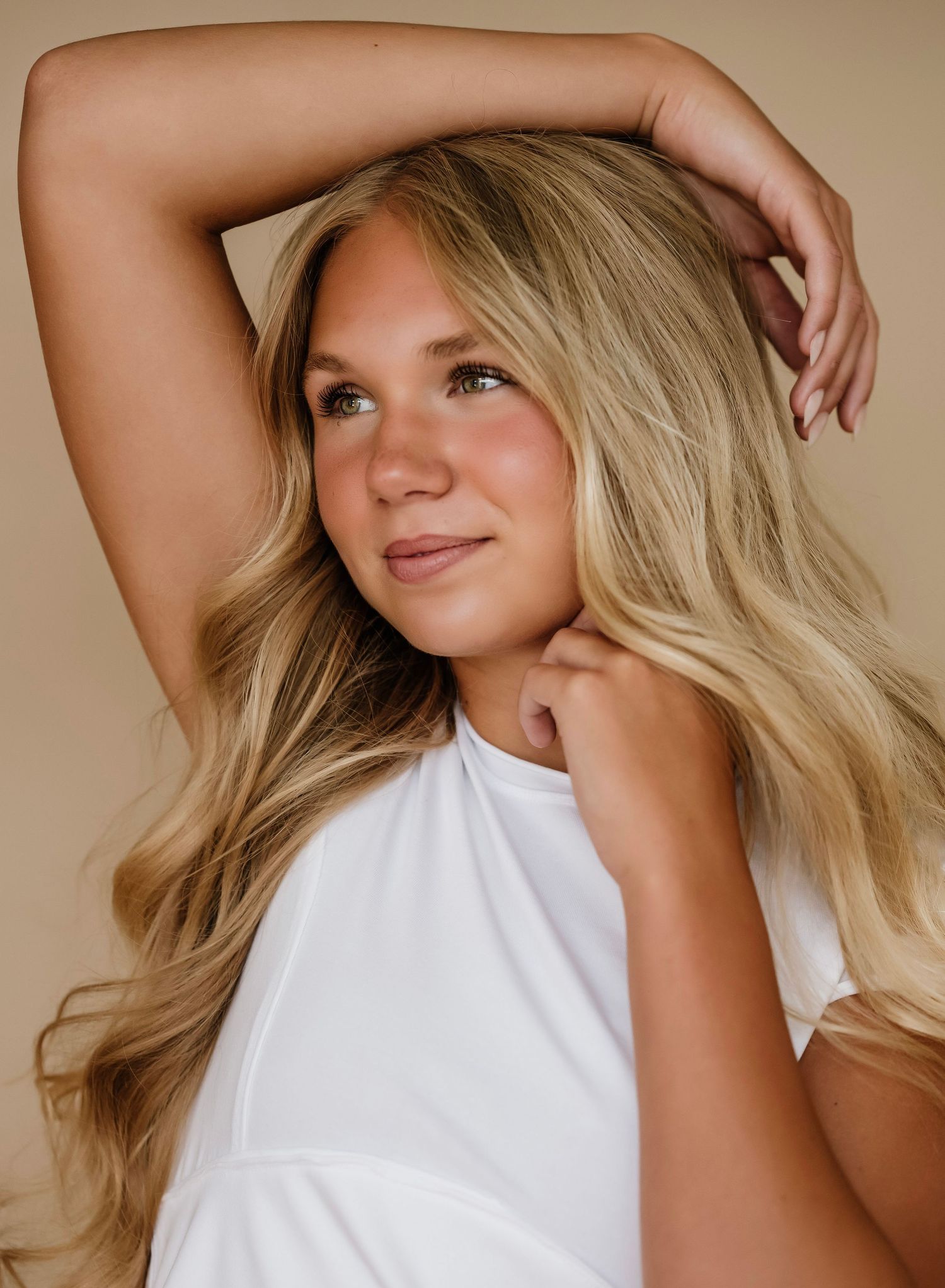 A series of five artistic portrait shots showing blonde hair and white clothing against a neutral beige background.
