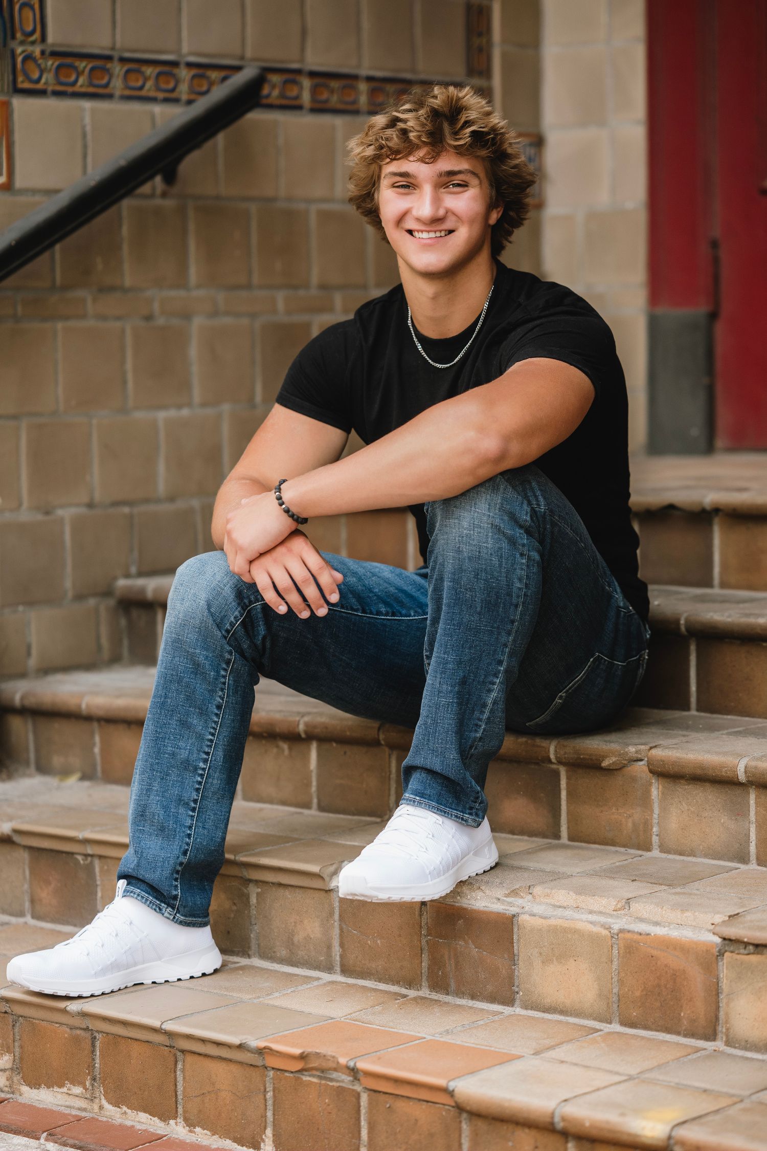 Three connected photos show someone sitting casually on tan stone steps wearing jeans and white sneakers.