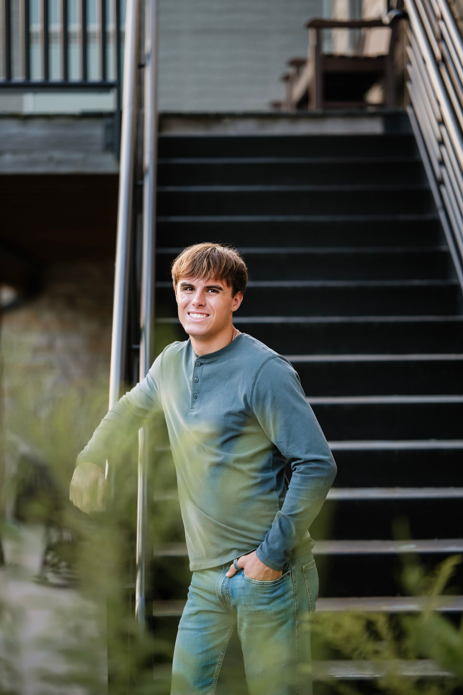 Person in a teal sweater poses playfully on outdoor stairs in a series of connected motion shots.