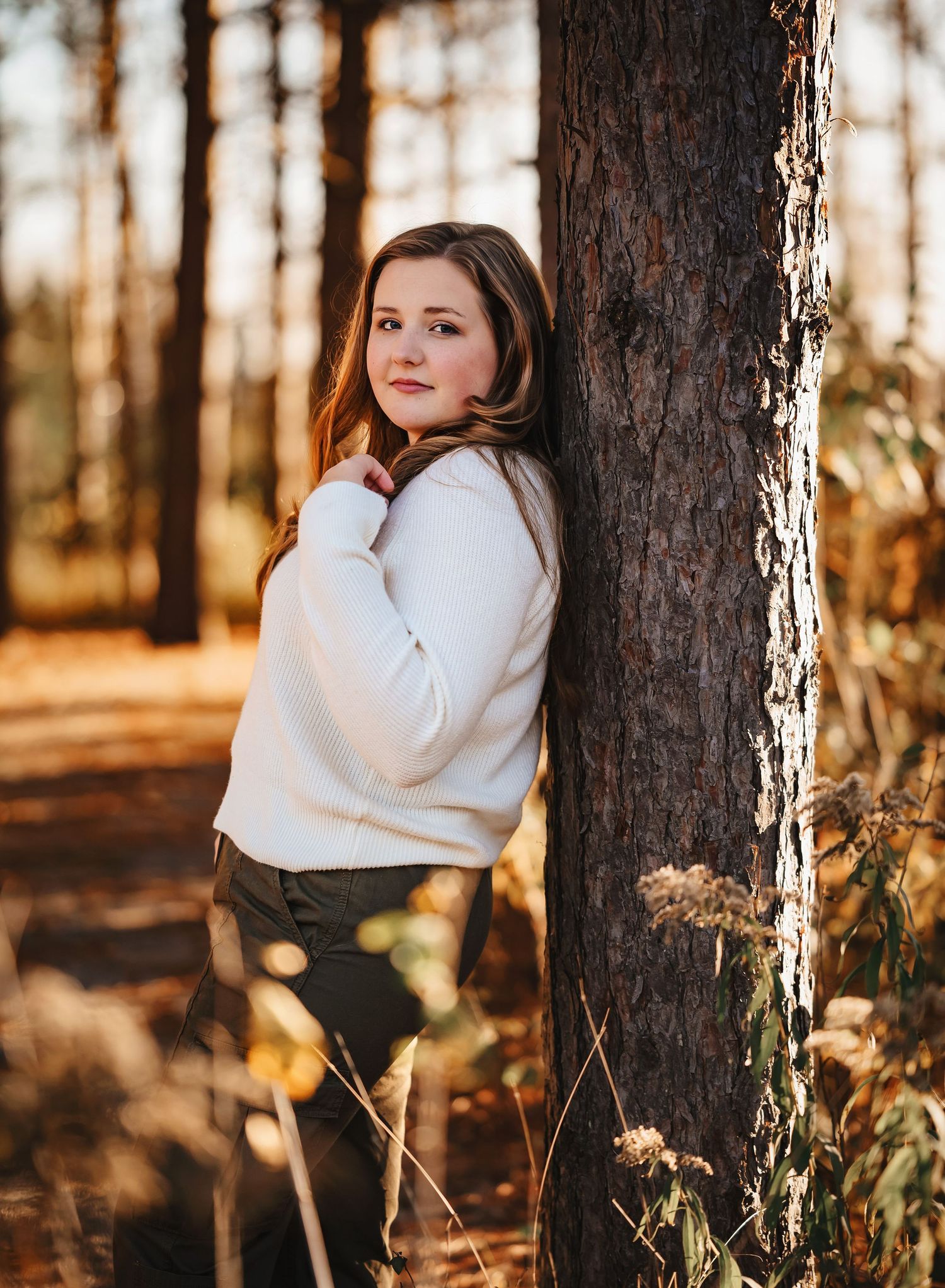 Moody forest portraits captured at golden hour with sunlight filtering through trees.