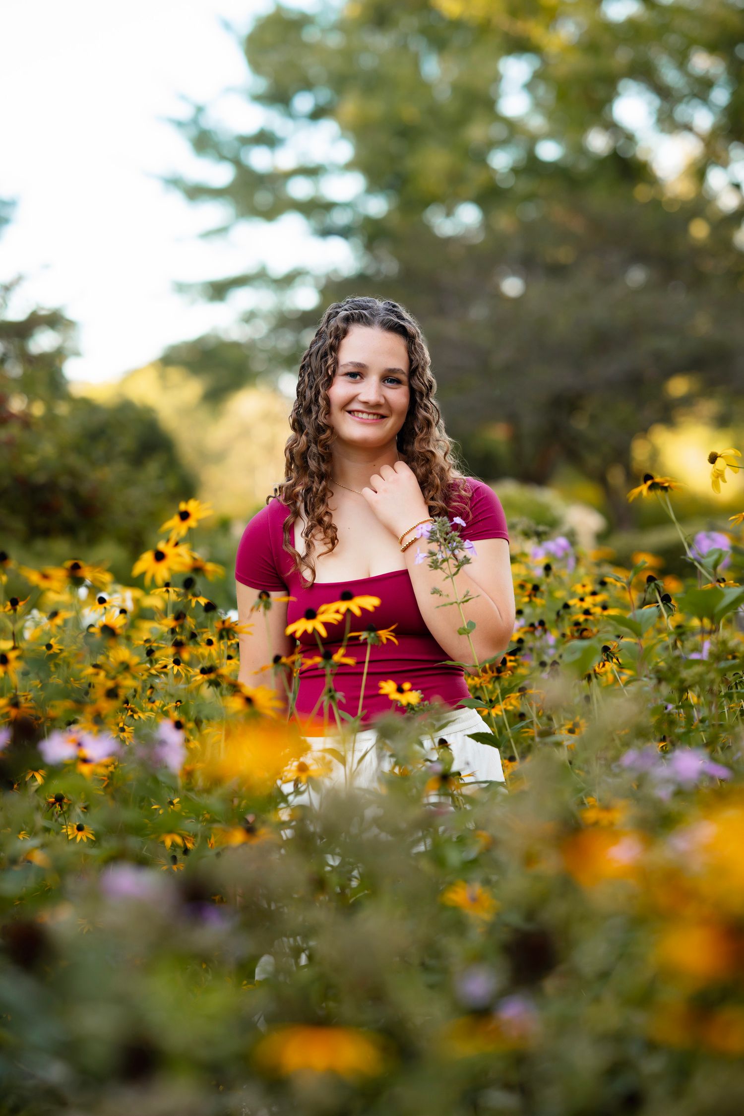 A joyful portrait session in a vibrant wildflower field with yellow and purple blooms during golden hour.