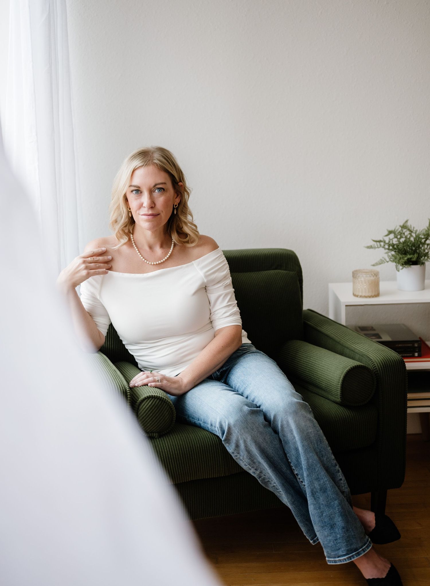 Relaxed lifestyle photos on a green couch in a bright, minimal home setting.