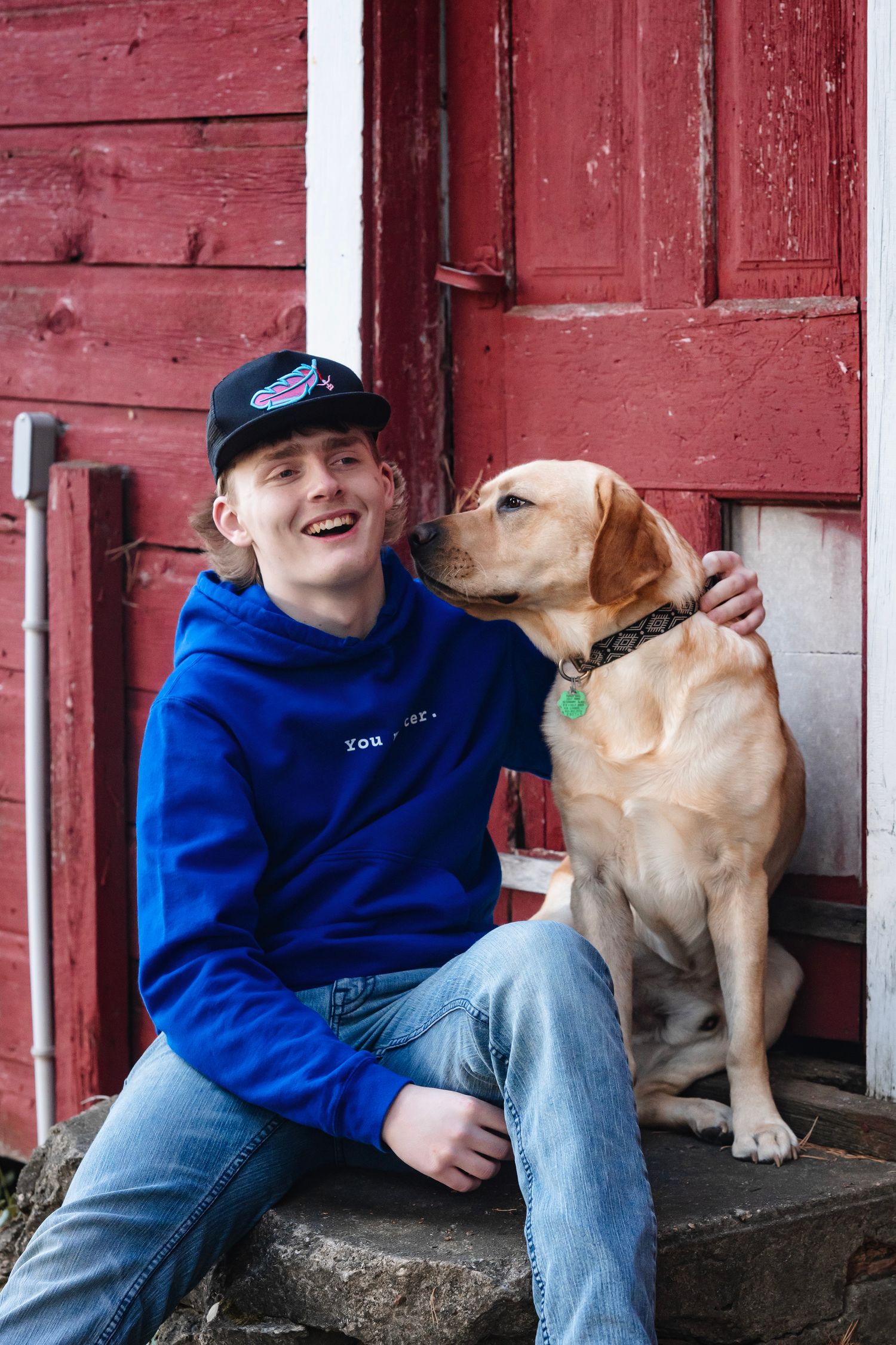 A heartwarming sequence of photos showing playful interaction between a yellow lab and someone in a blue sweater.