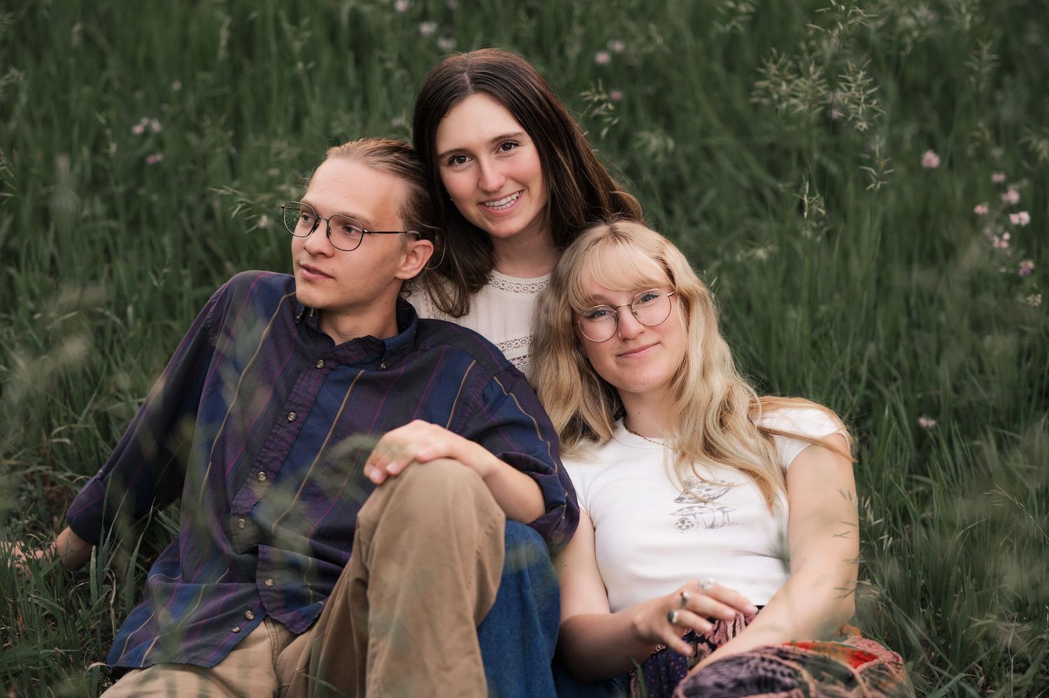 Band portrait session in a lush green field.