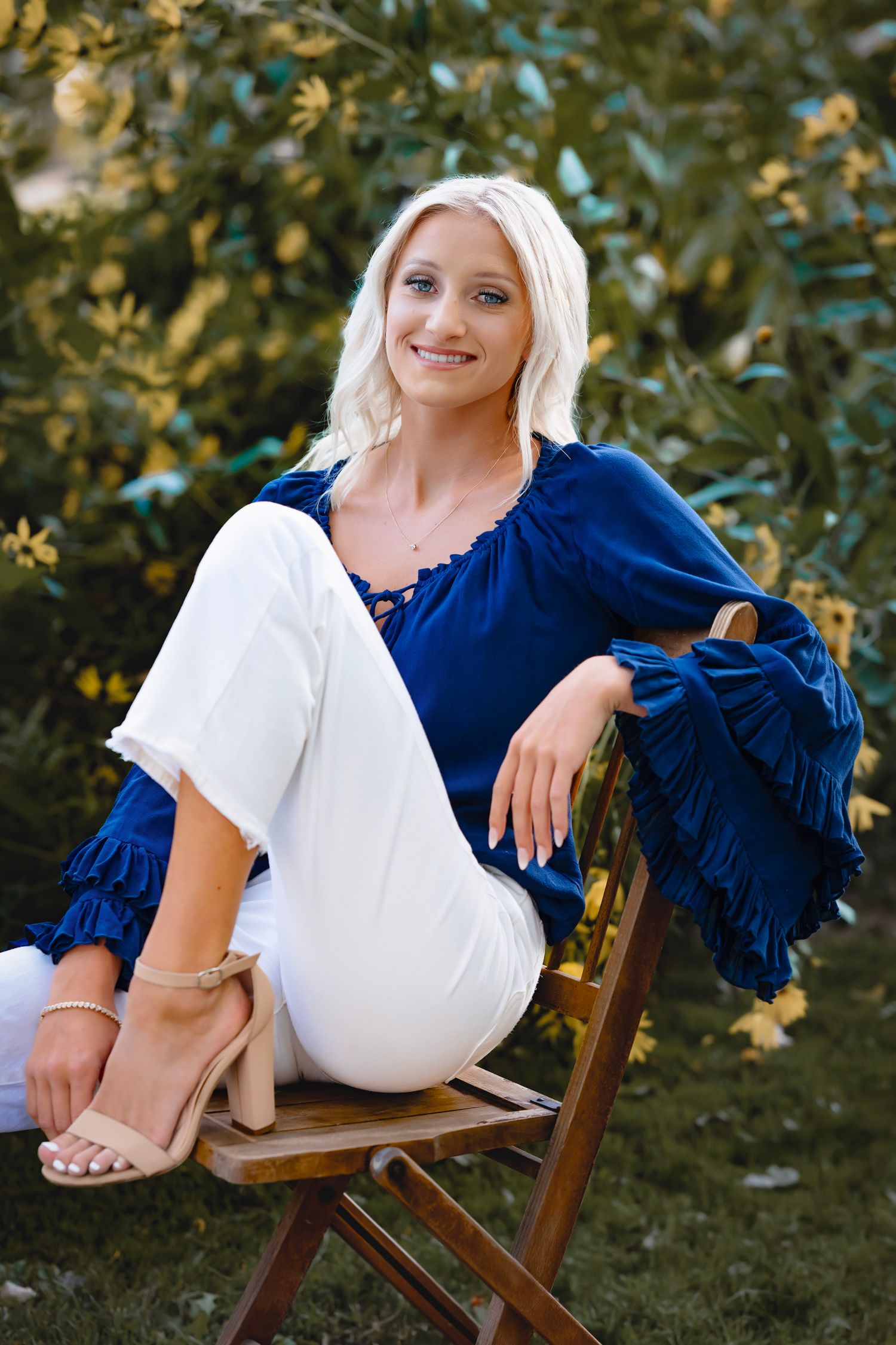A series of casual outdoor portraits showing someone in a white top and navy blue sweater relaxing on a wooden chair.
