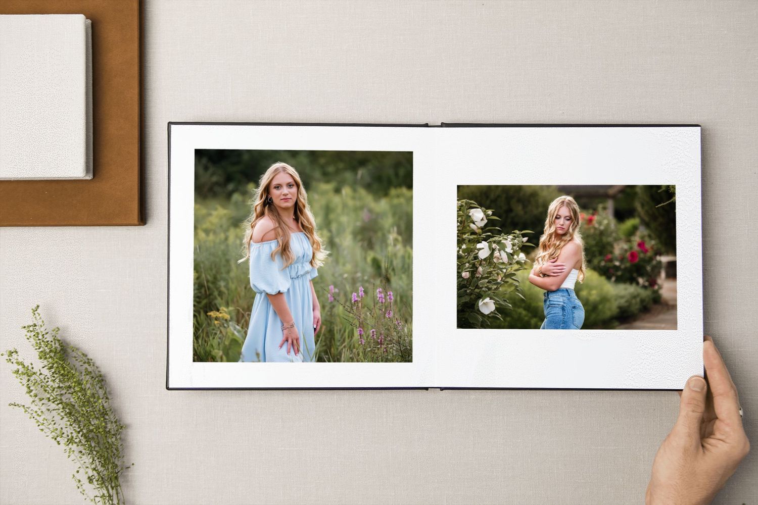 A collection of framed portrait photographs arranged on a white wall with a wooden trim.