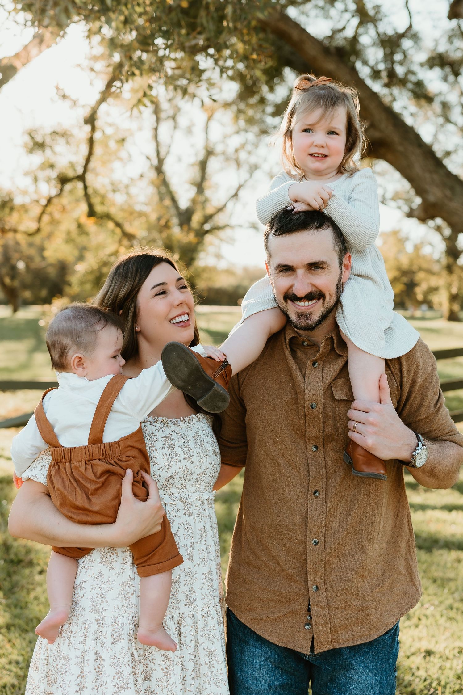 Candid family moments captured in golden sunlight during outdoor photoshoot.