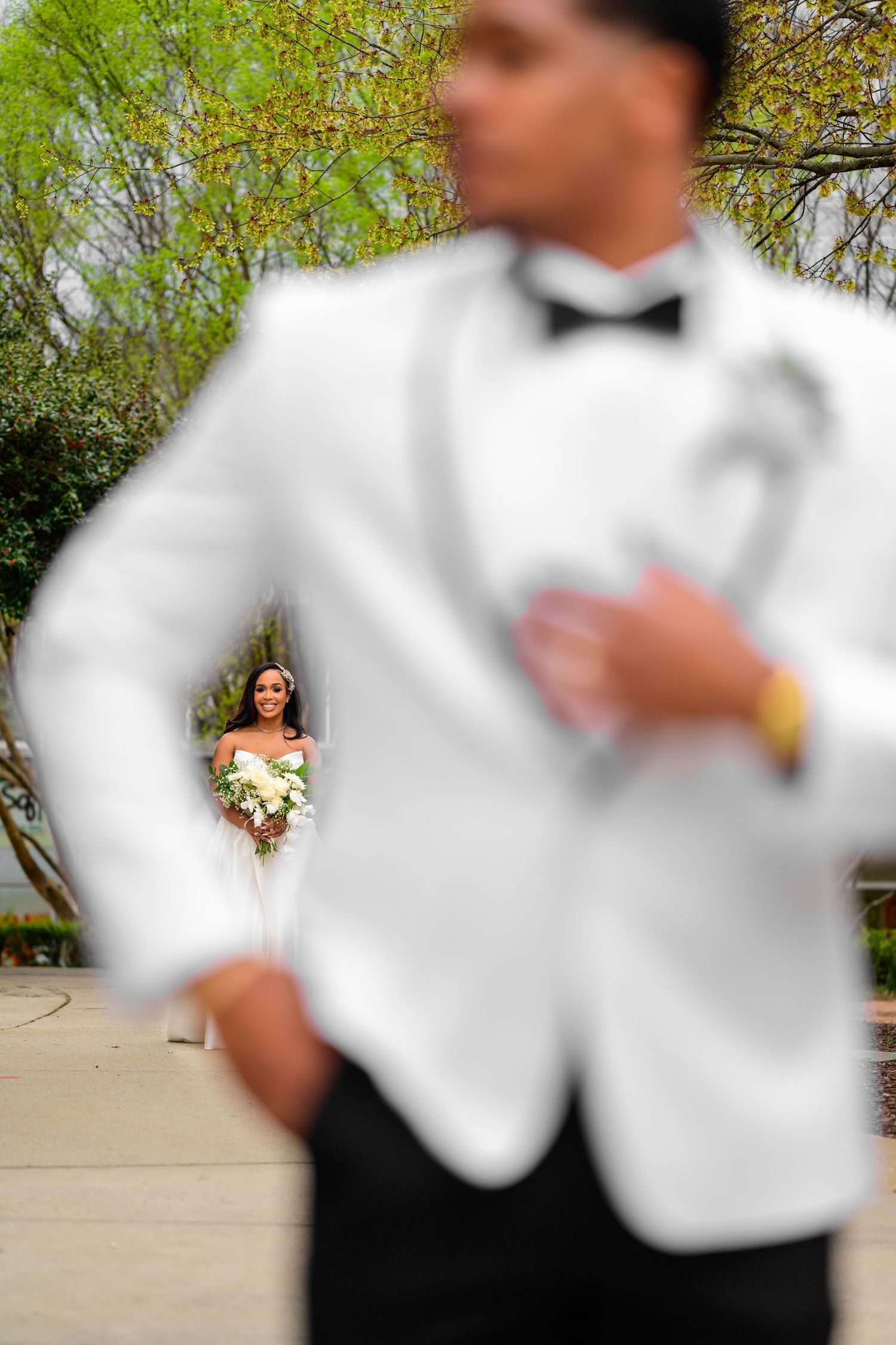 Creative wedding photography sequence with white tuxedo in foreground and bride in background.