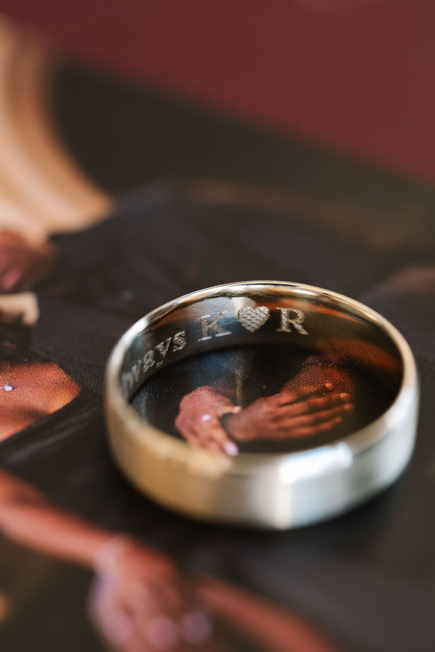Close-up macro shot of silver wedding rings with reflective surface.