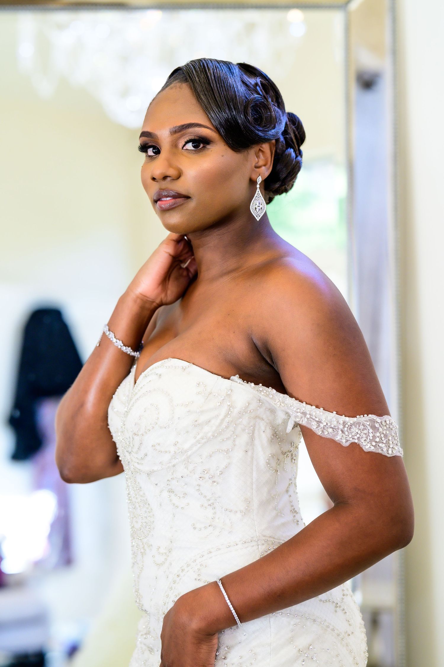 Elegant strapless white lace wedding gown with intricate beading and embellishments.