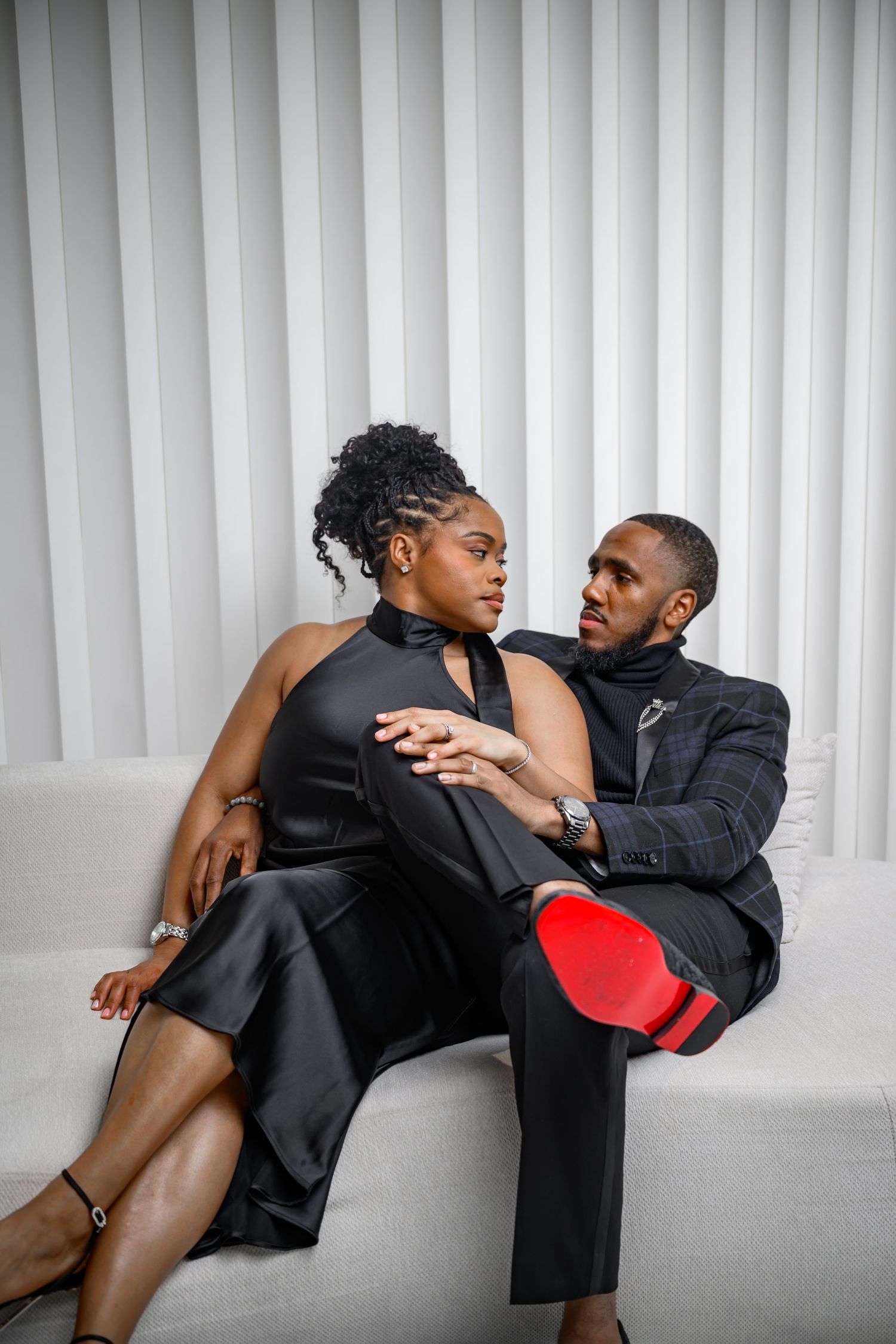 A series of artistic black and white fashion photos showing two people posing dramatically against a white background.
