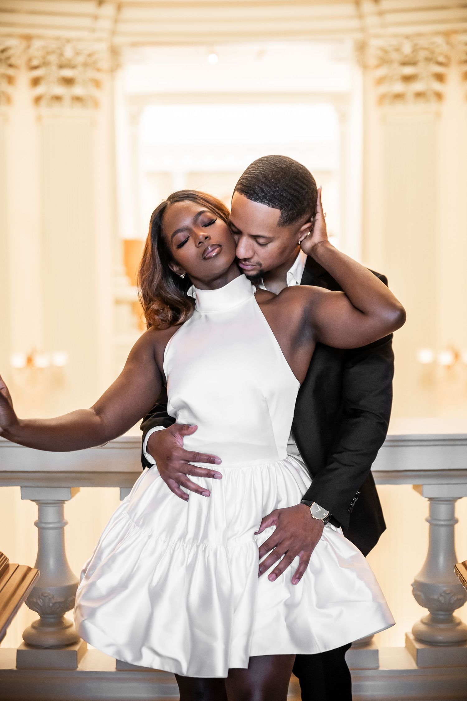 Romantic dance sequence along an ornate balustrade in warm lighting.
