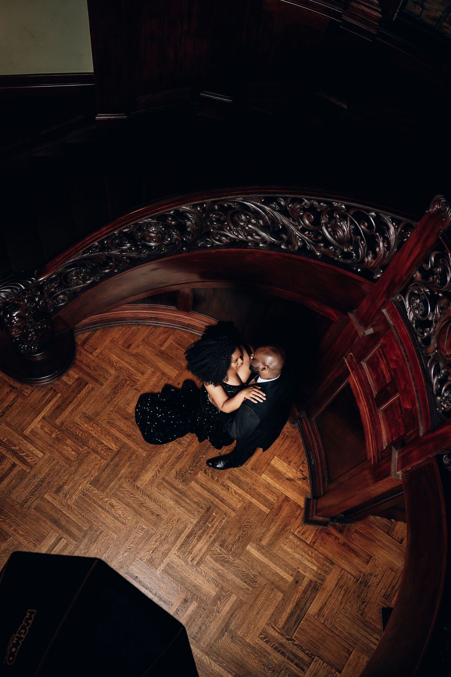 Artistic overhead shots on wooden floor showing couple in formal attire.