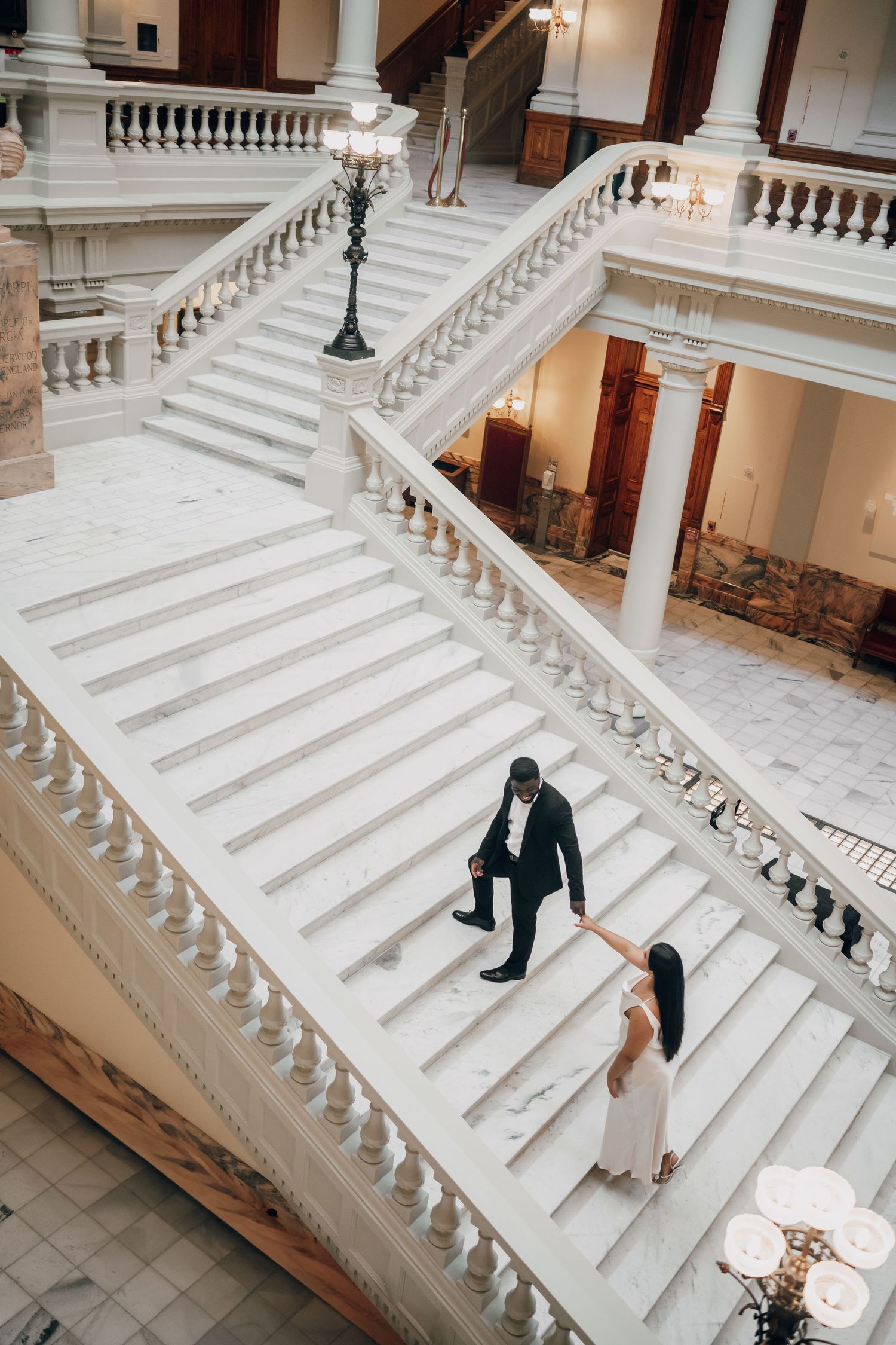 Elegant wedding photography session on historic white marble staircase.
