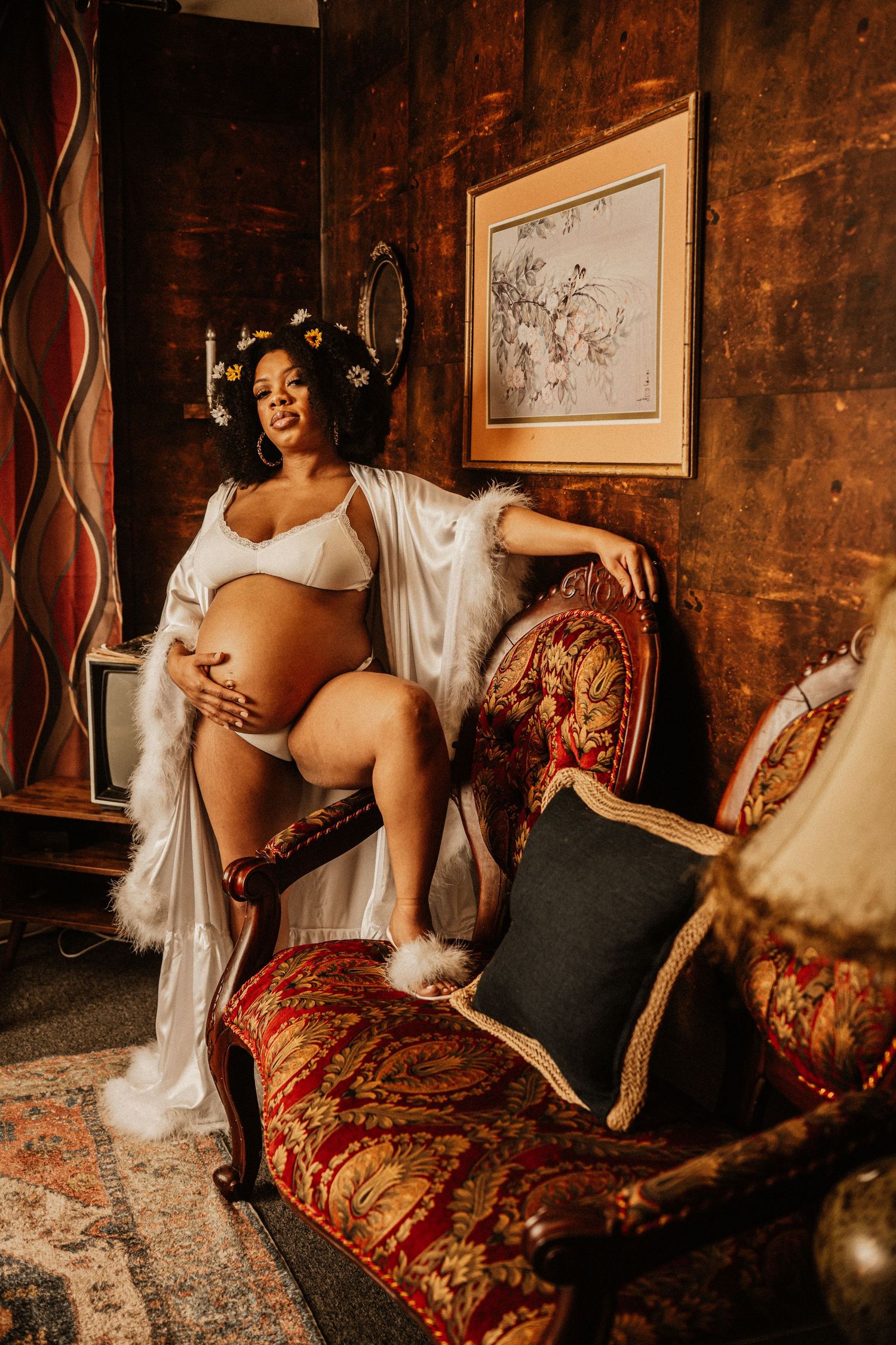 Vintage-styled boudoir photography session with antique furniture and moody lighting.