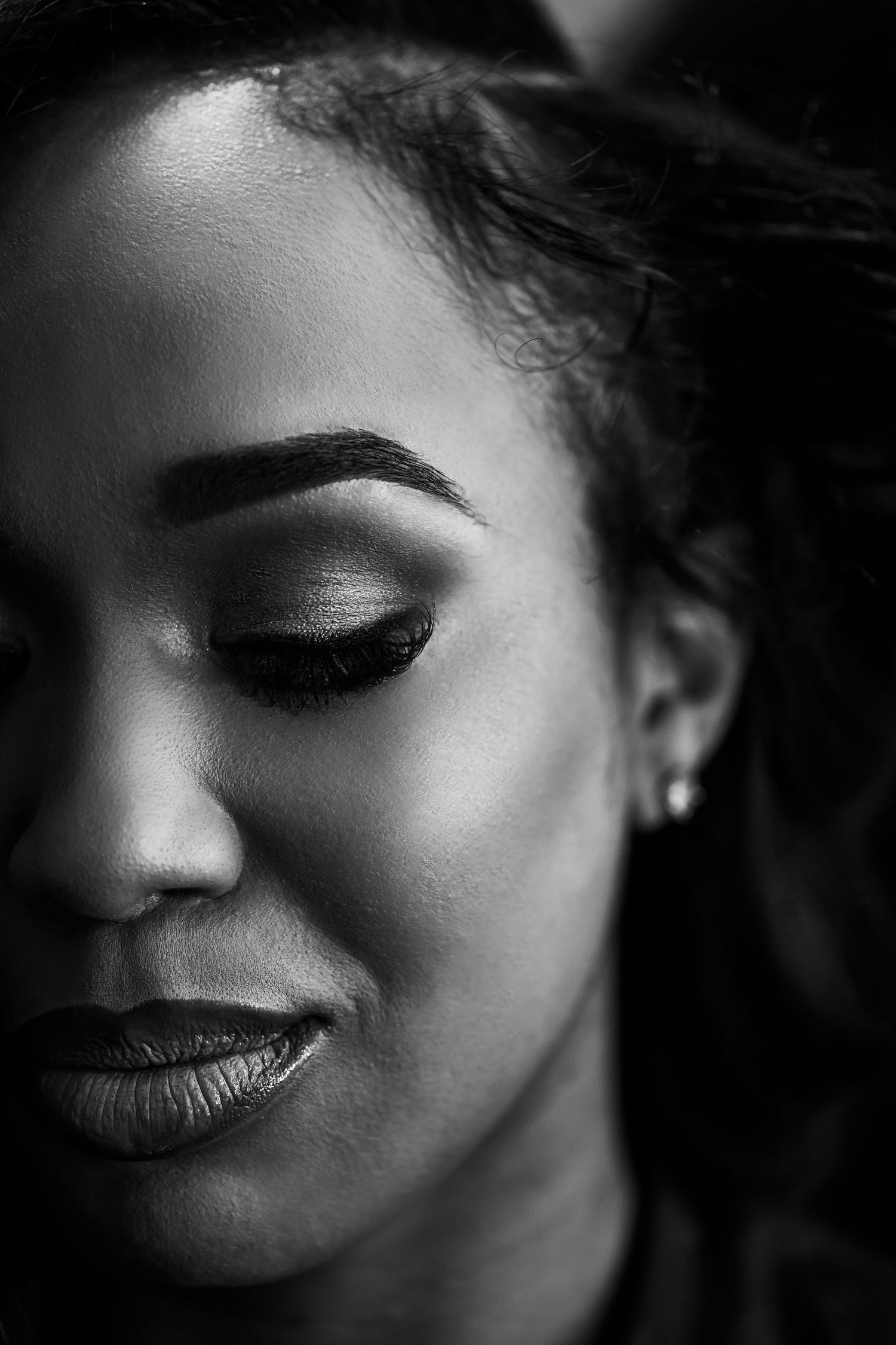 Dramatic black and white beauty portrait showing elegant makeup details.