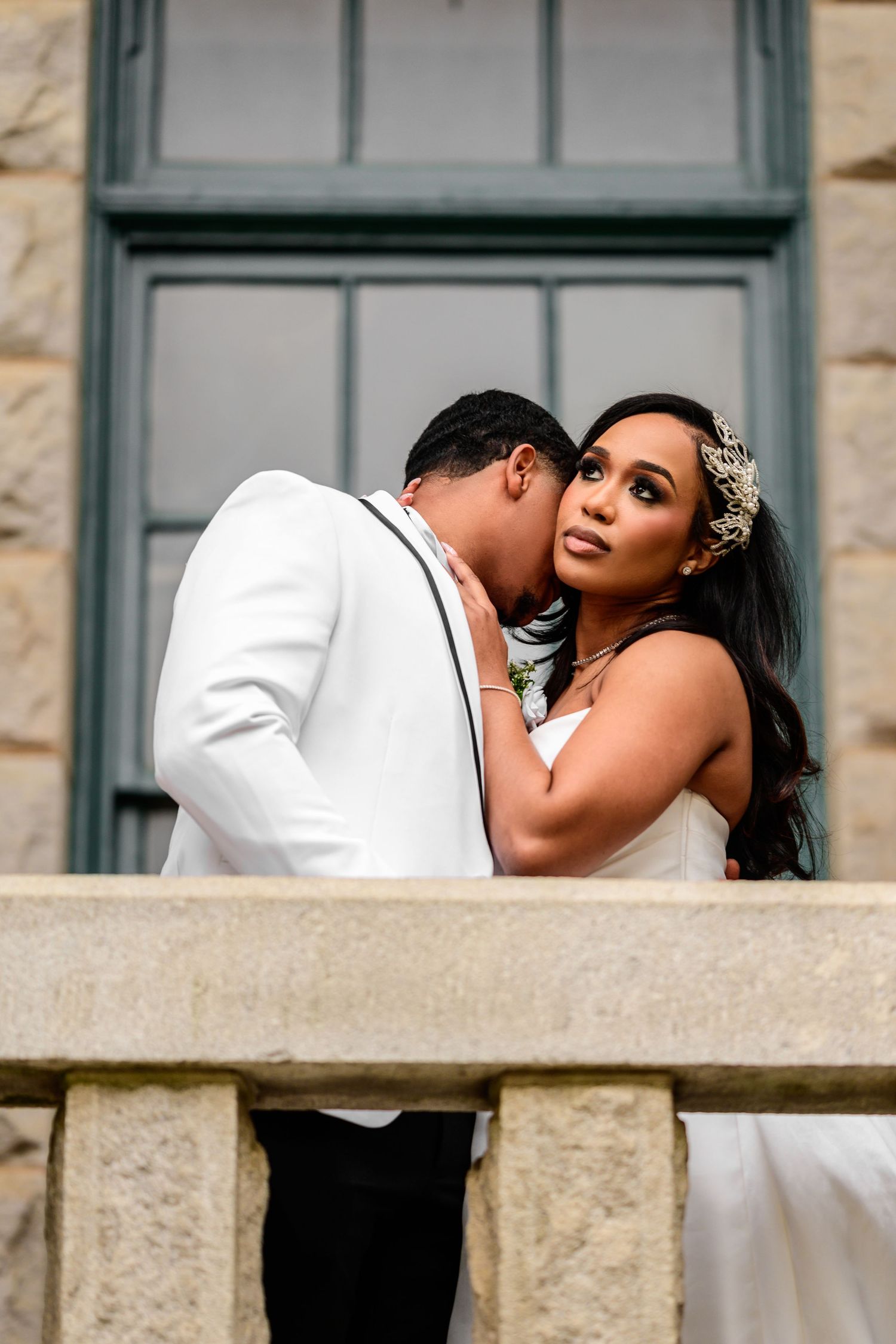 Intimate wedding portrait captured through architectural framing.