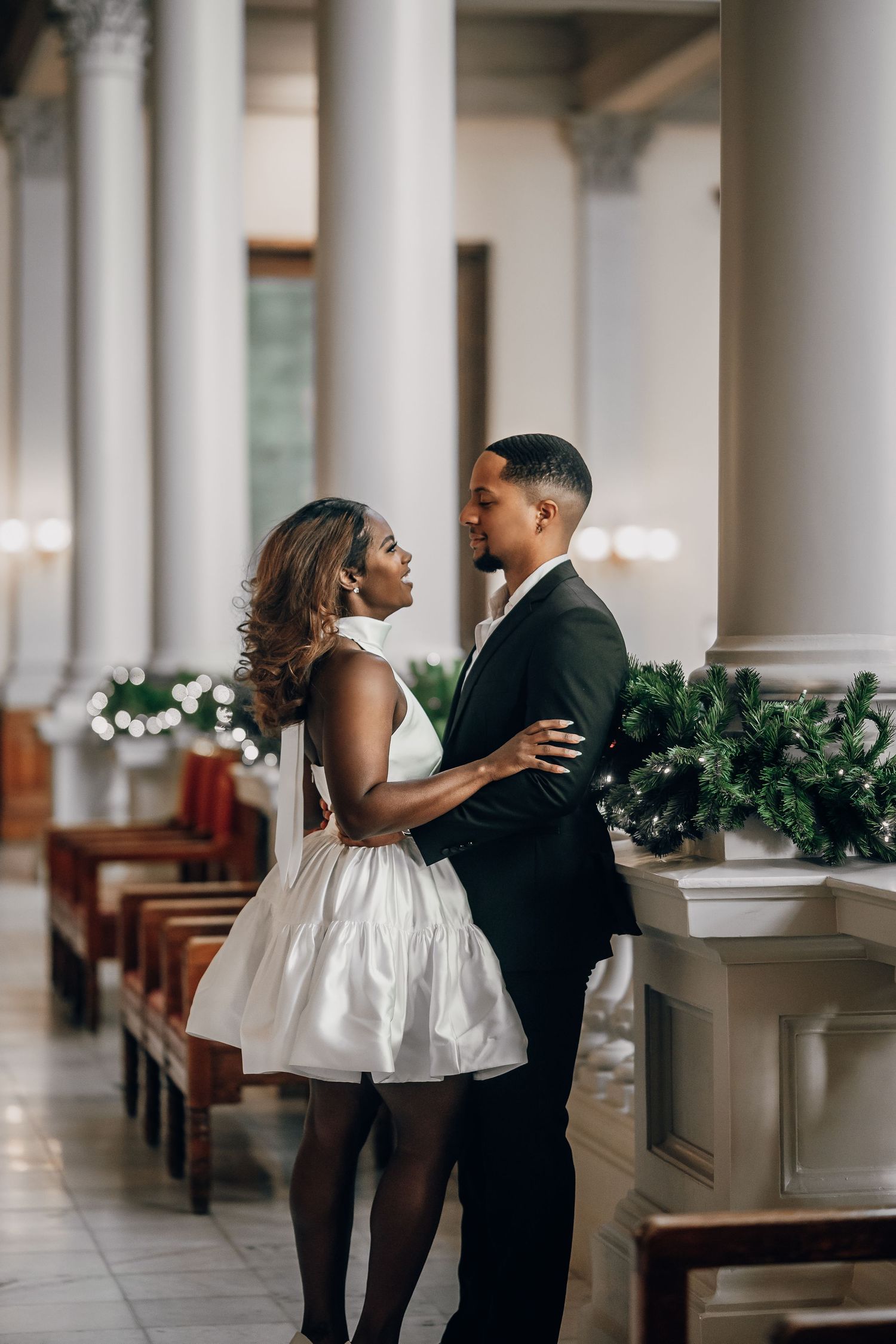 Romantic dance sequence in formal wear along a classical colonnade.