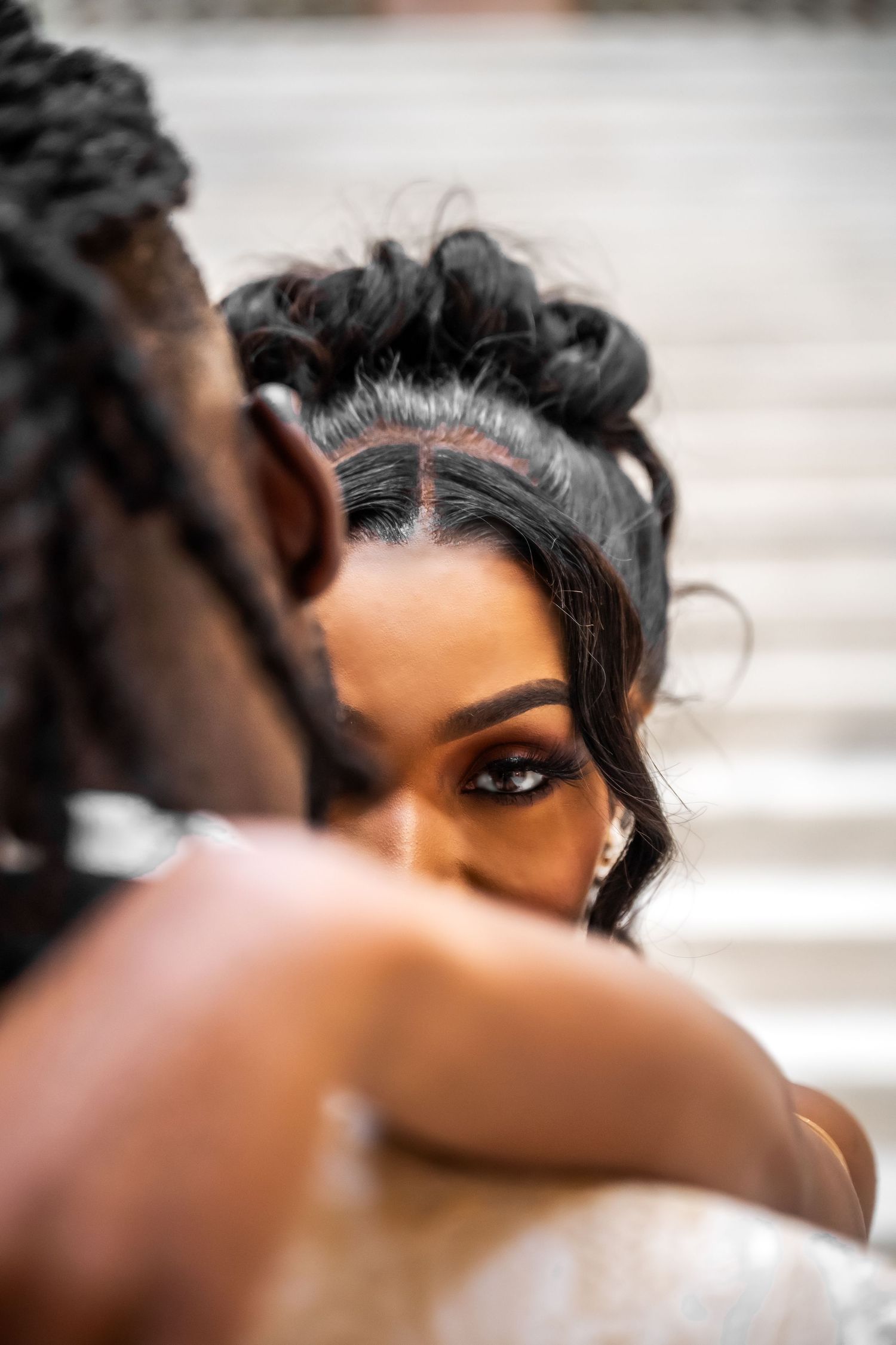 Artistic close-up wedding photography shot focusing on eye makeup and hairstyling.