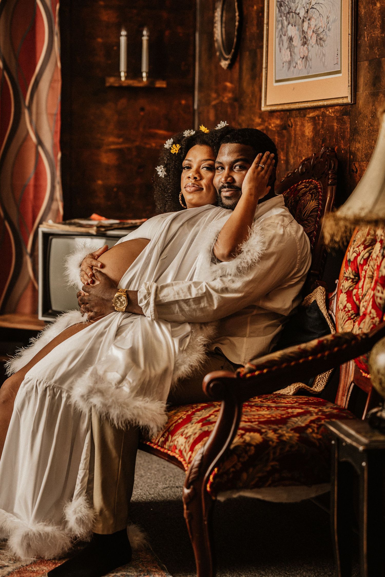 Candid moments captured on antique furniture with white flowing fabric and vintage decor.