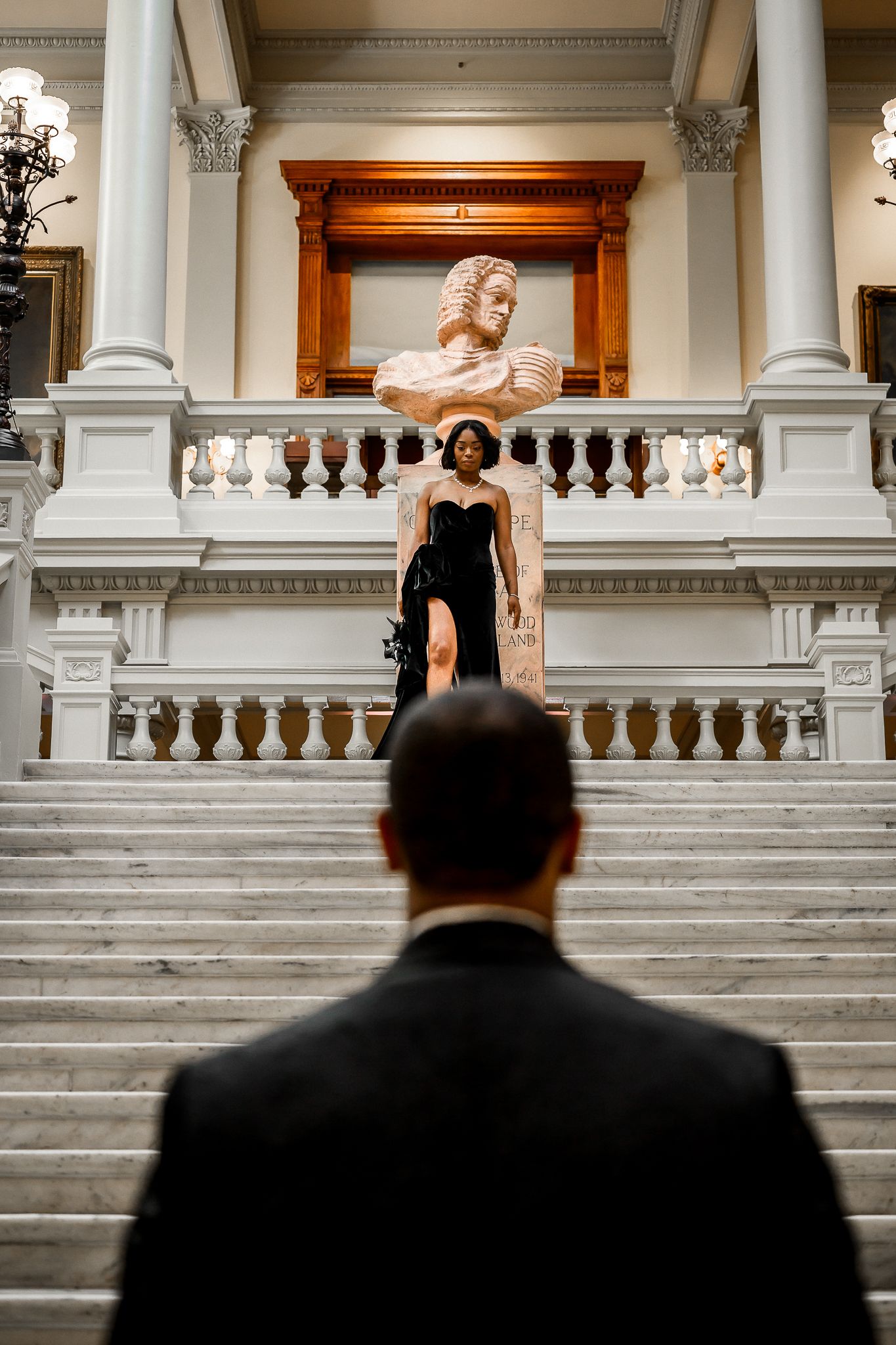 Grand white marble staircase with classical columns and architectural details.